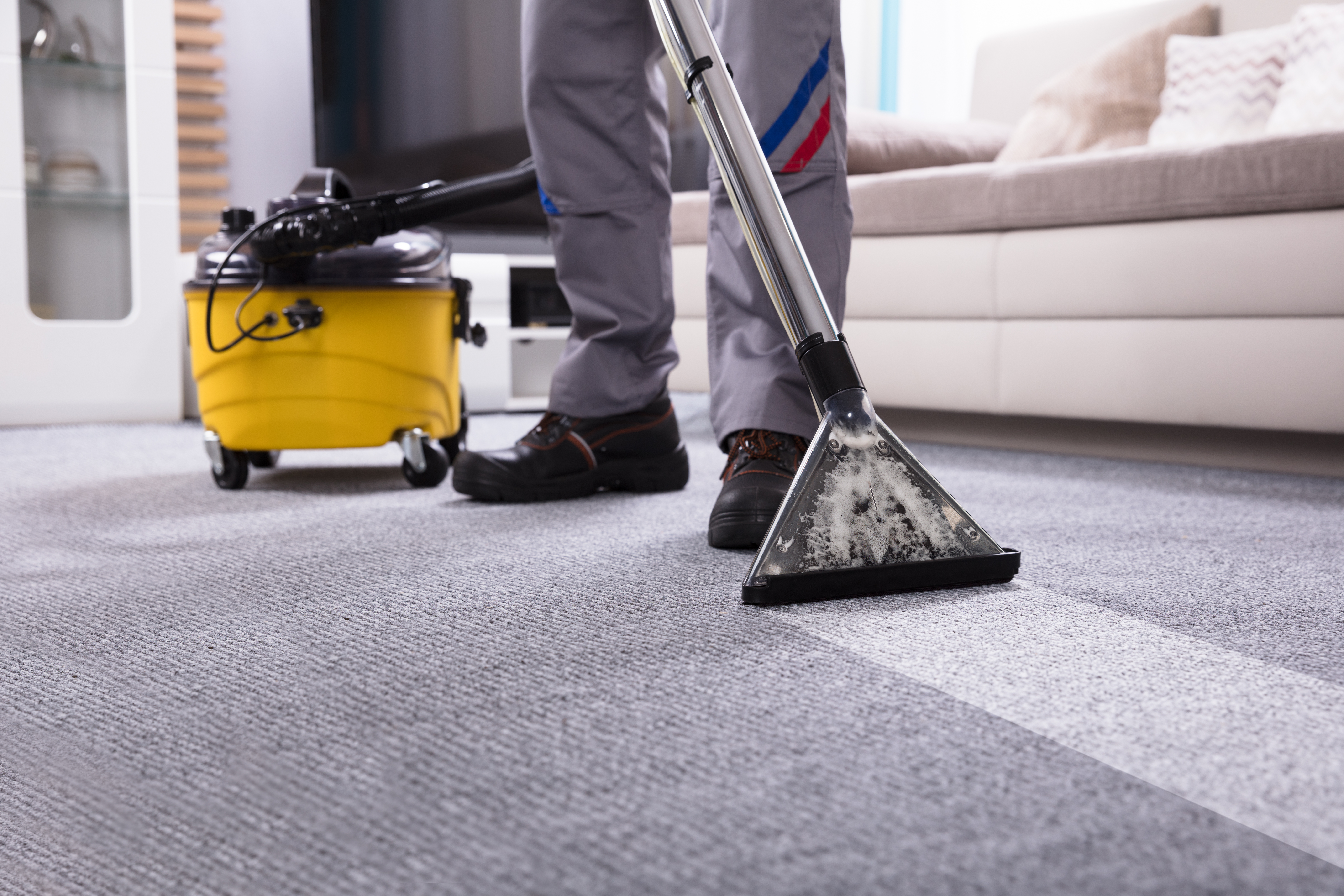 Mastering Carpet Stain Removal: Tips for Tackling Tough Stains and Preserving Beauty 7 person cleaning carpet with vacuum cleaner 92ad029f73a06d07a37e