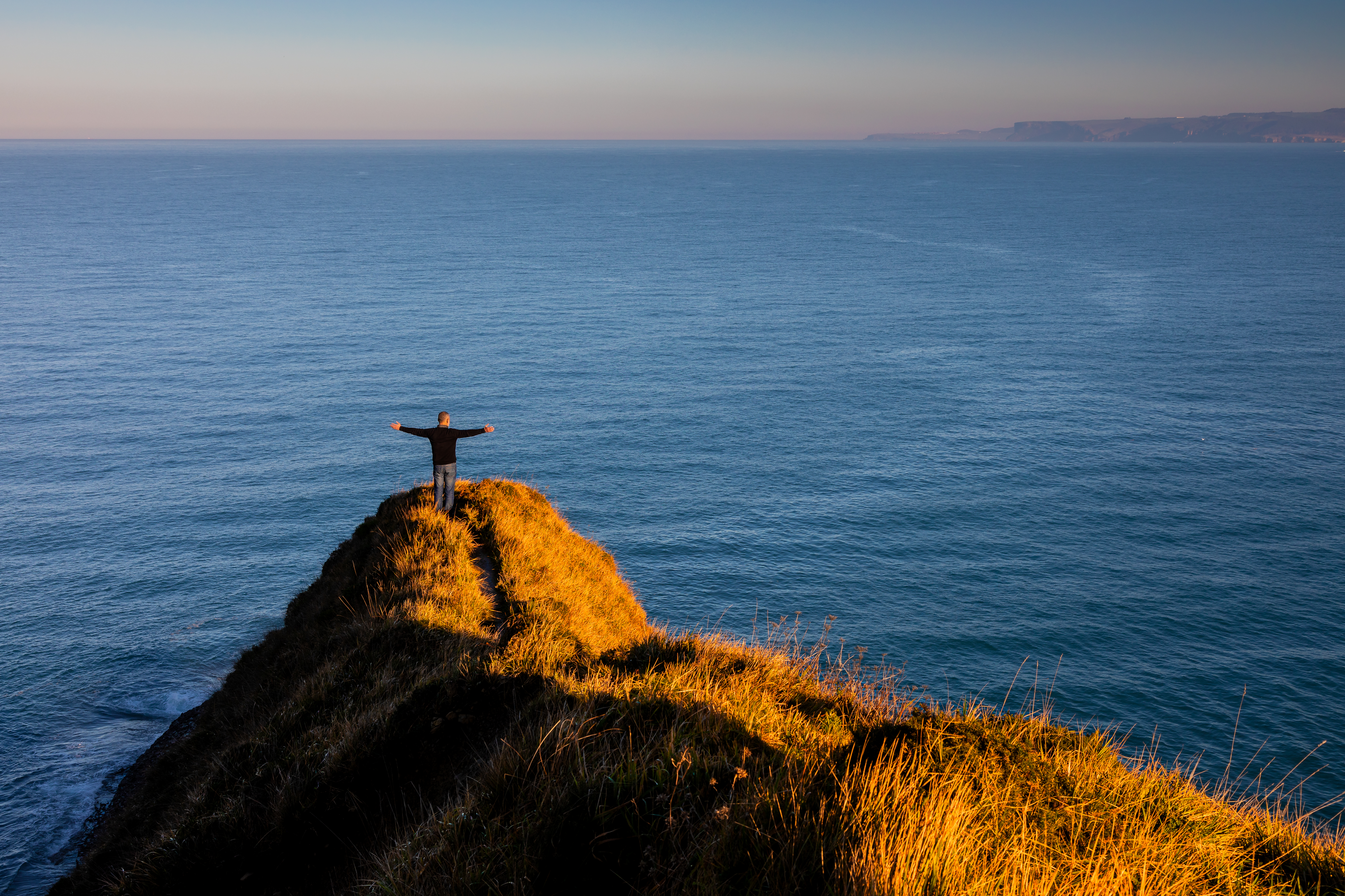 person with a sense of freedom on a cliff with a p 0de695e59109af7425b9 BTOURS