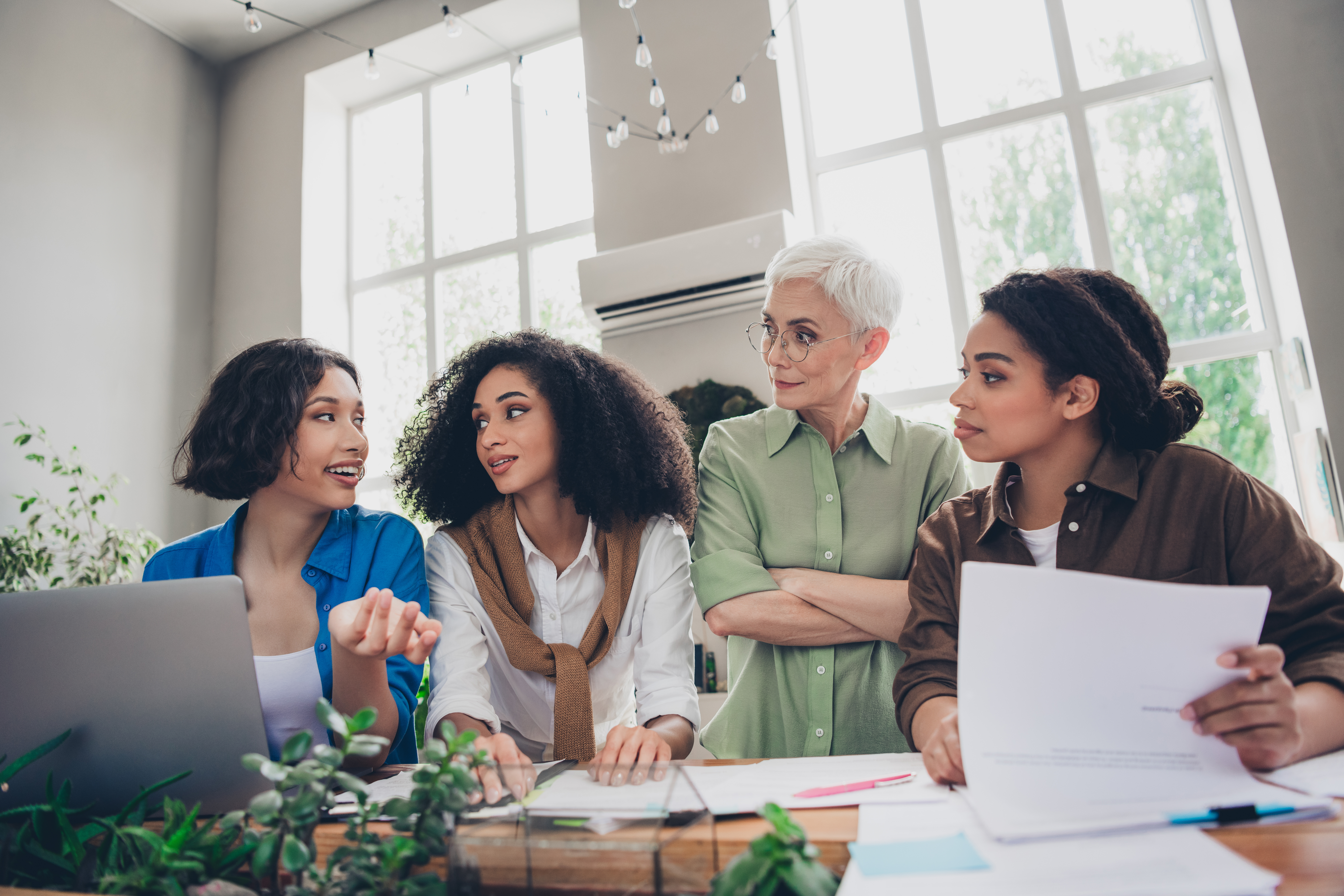 Unveiling the Roadblocks: Conquering the Hidden Challenges of Starting Your Own Travel Business 2 photo of corporate four colleagues women feminists d050dab11cb9401c4280