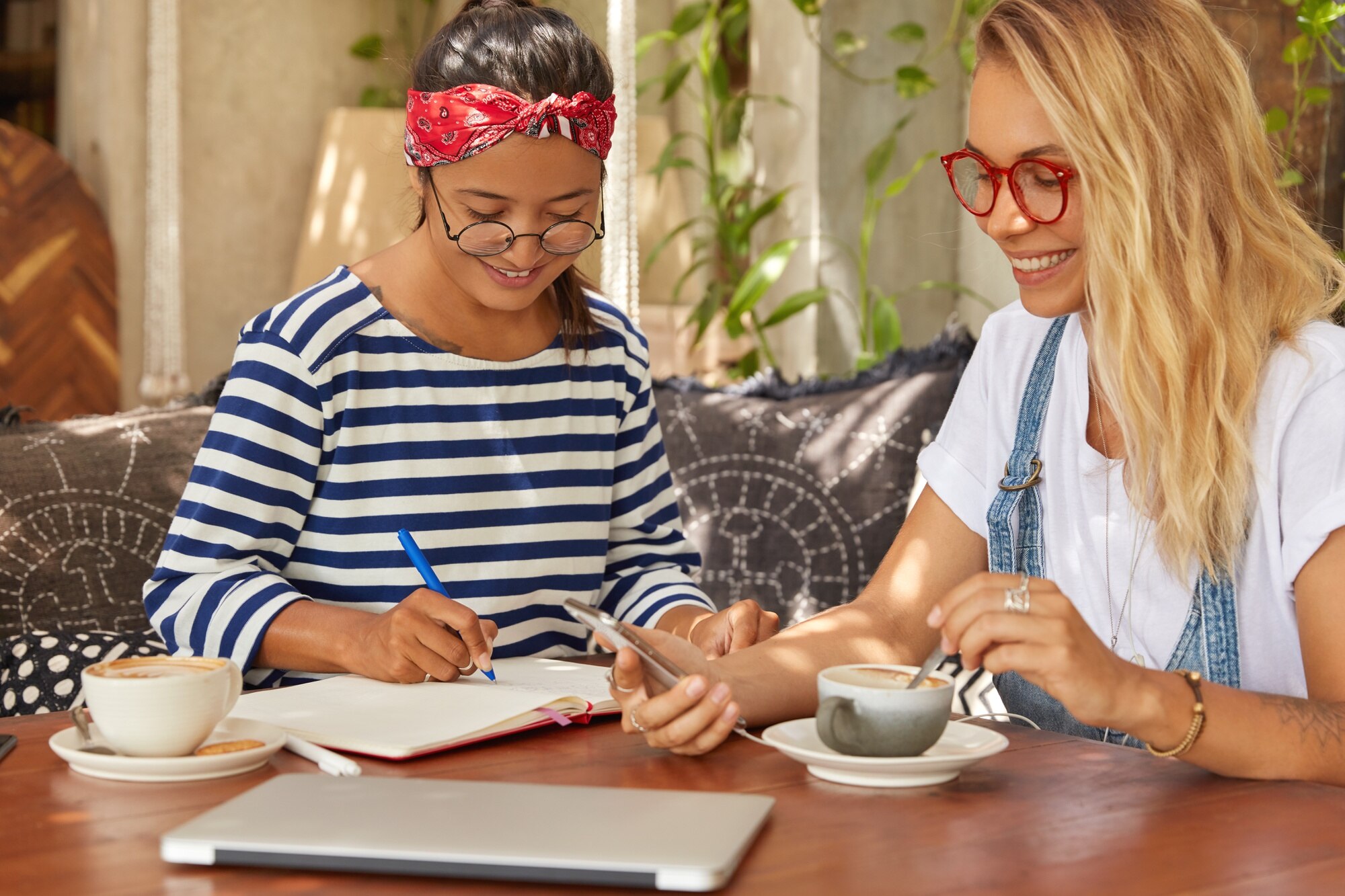 photo of two multiethnic women sit together at cof d866dd9a020582b2fb95