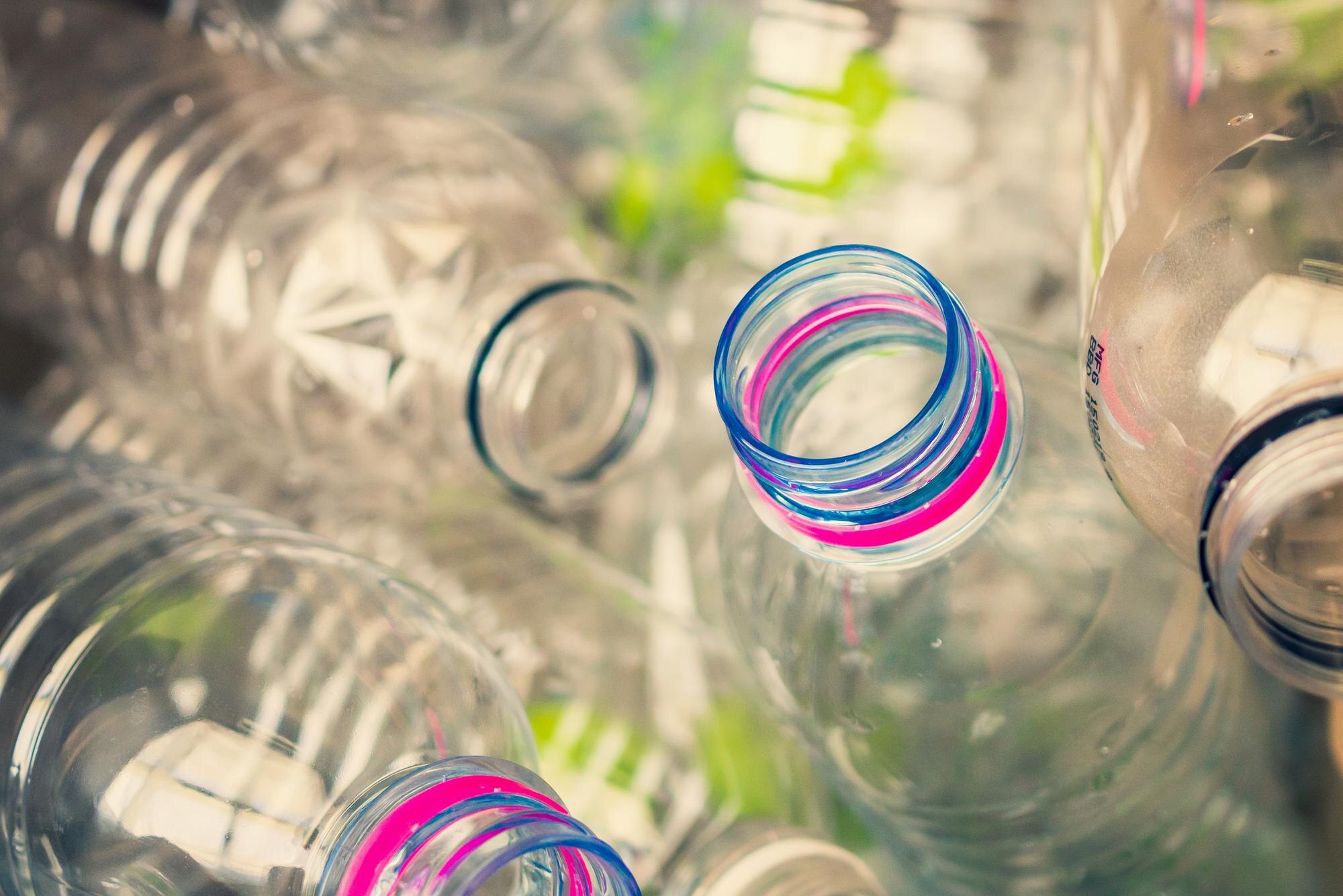 Stop Paying for Offcuts: How Precision Plastic Fabrication Slashes Waste and Costs 2 plastic bottles recycling background concept 6e4c06877d62a29467f3