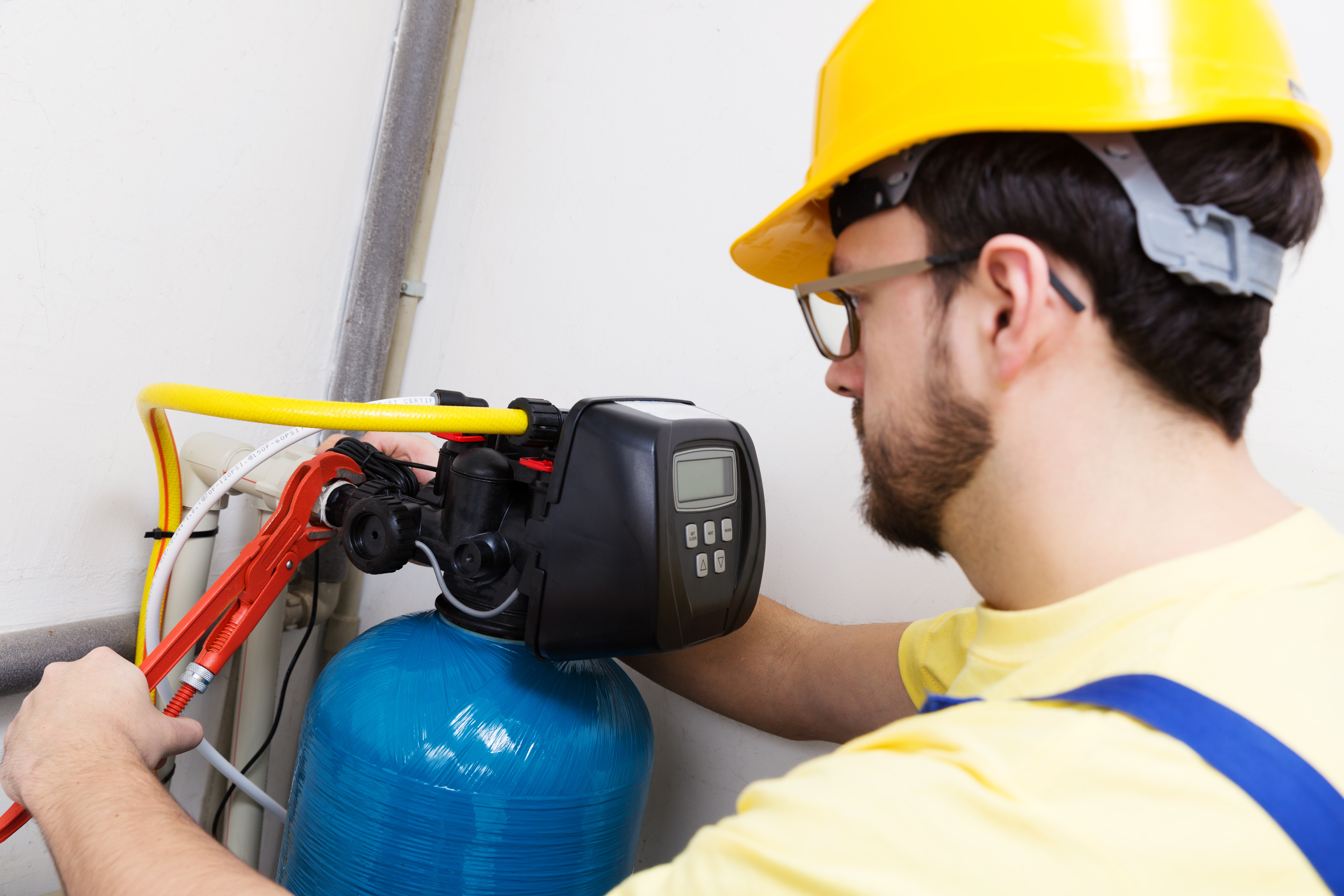 man installing water softener