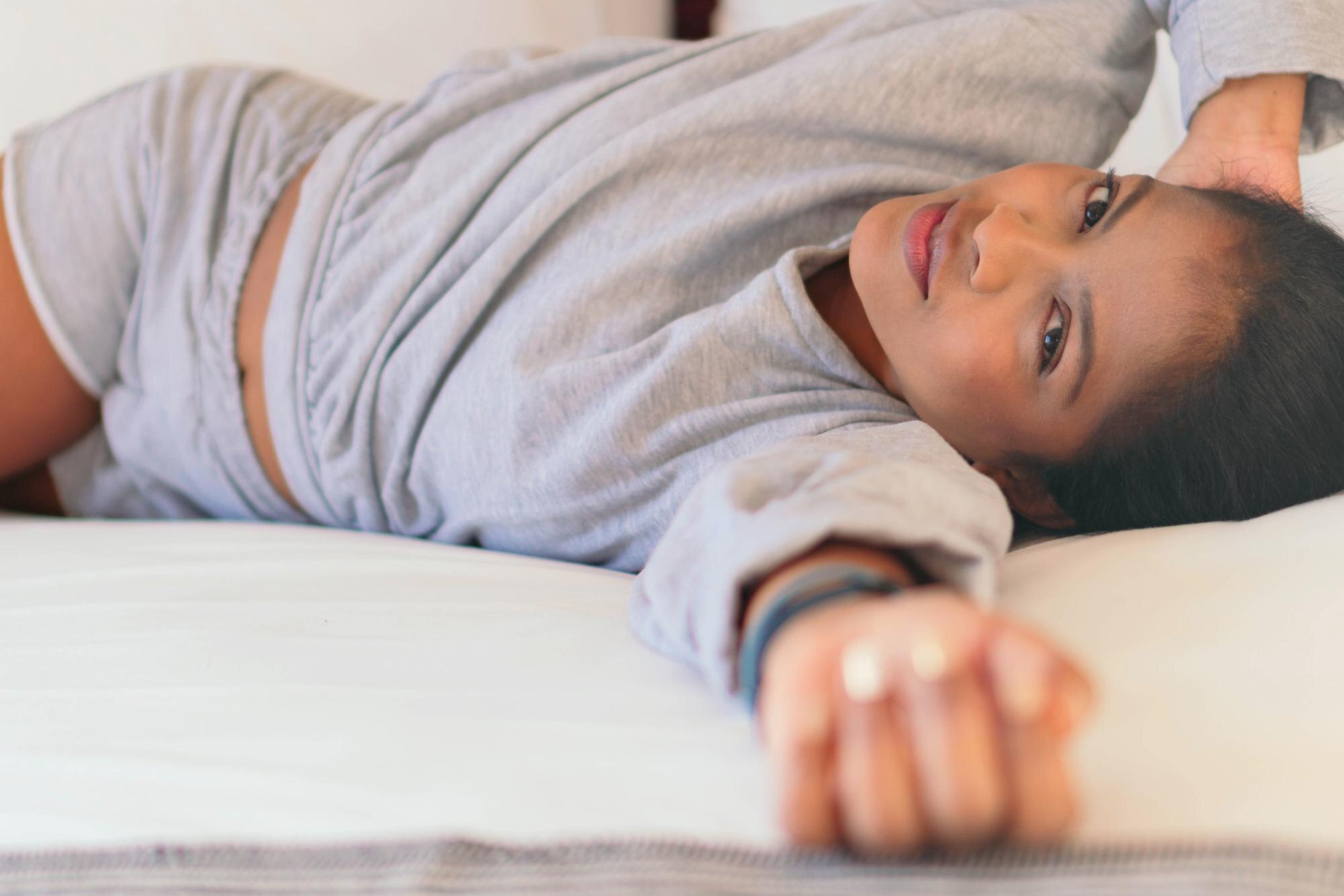 portrait of beautiful african woman lying on bed 63de4a4644f5f9899365