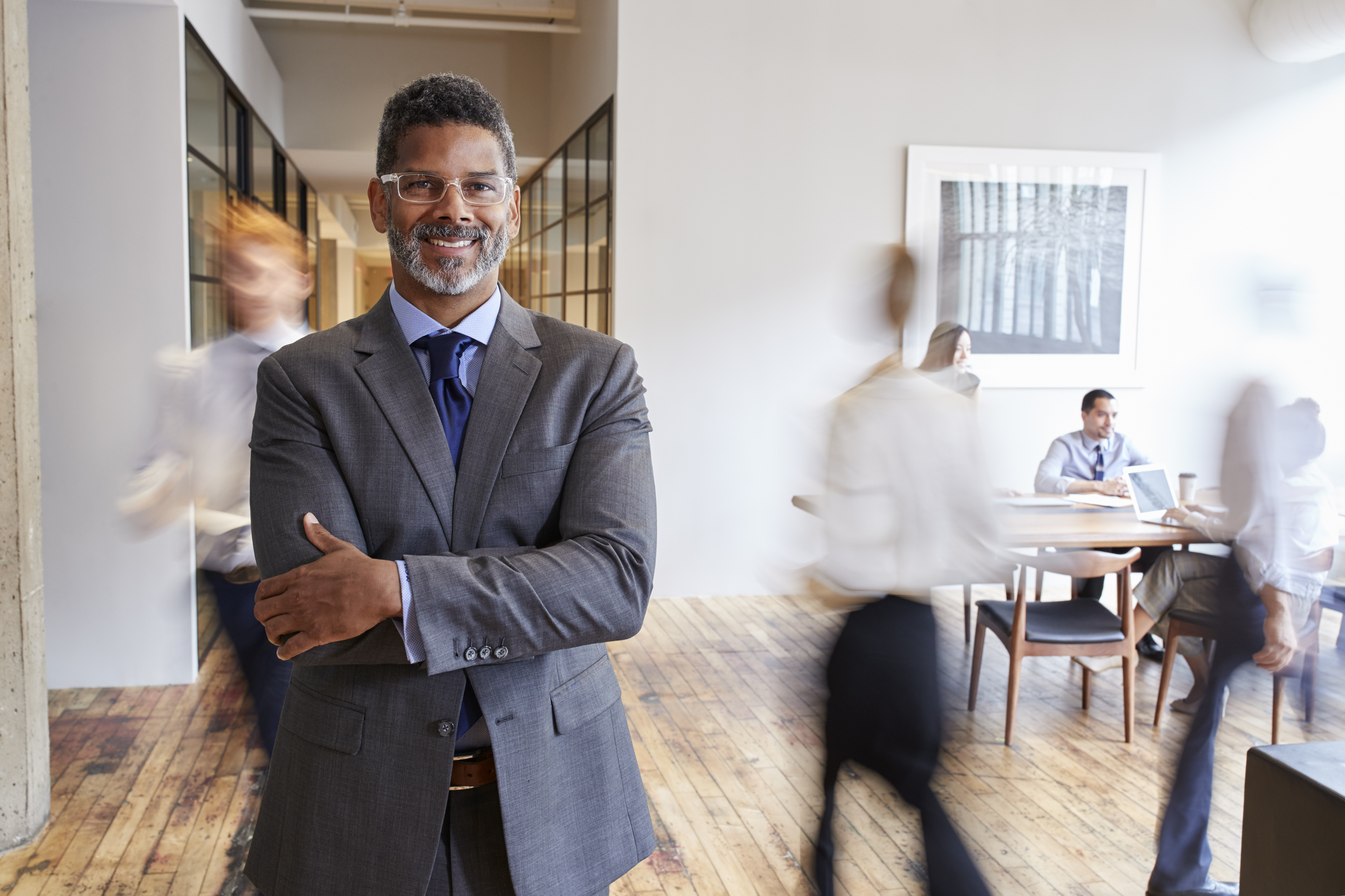 Navigating Career Transitions in the Energy Sector: Overcoming Uncertainty with GeoModes' Expert Guidance 3 portrait of middle aged black man in a busy modern 1058e94e1c9fd4b8e2a0
