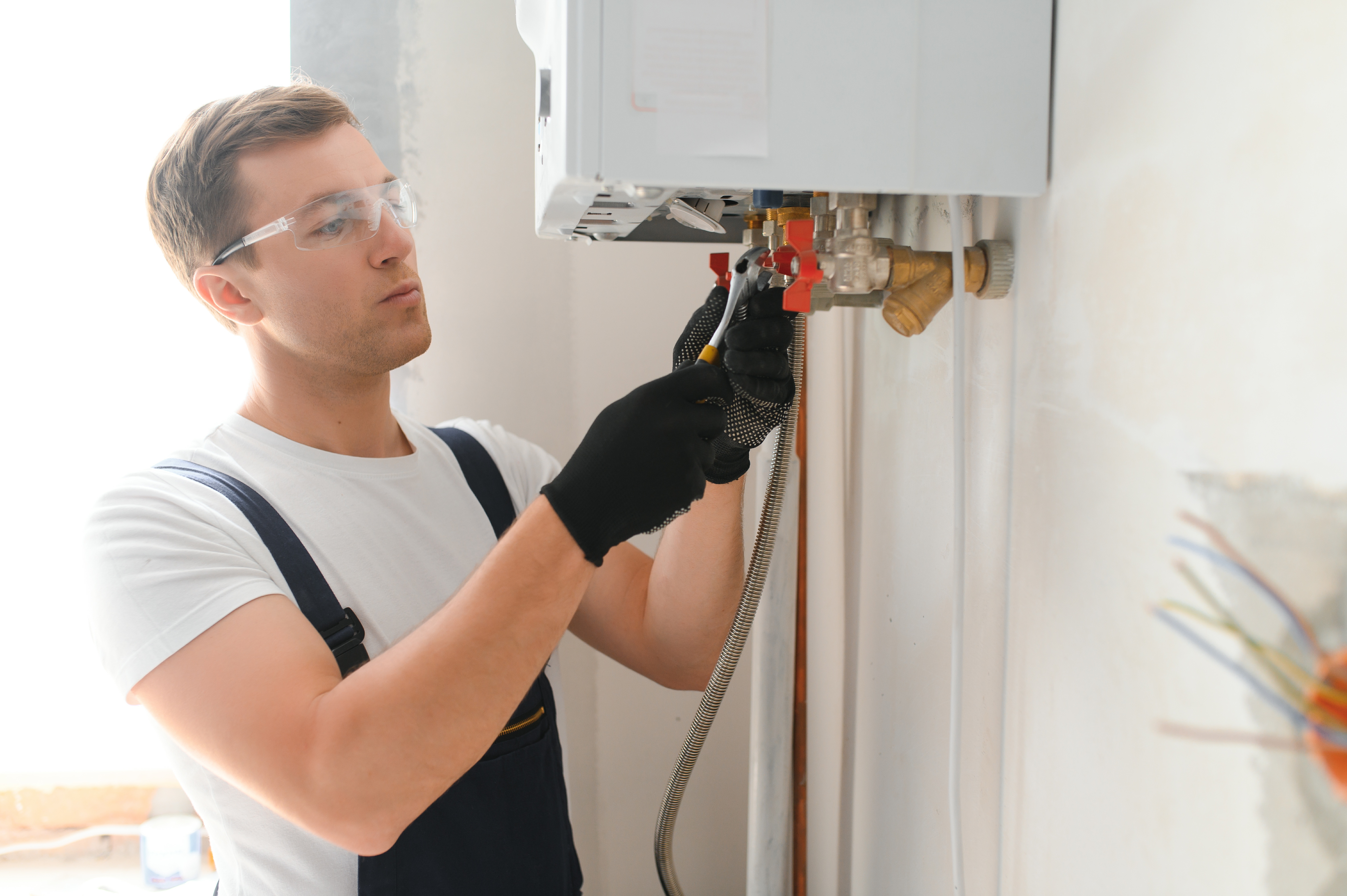 man fixing tankless water heater