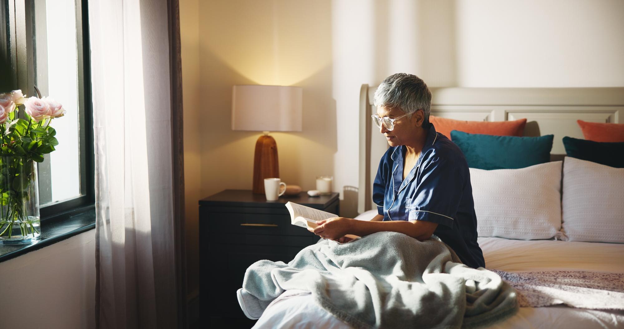 reading relax and senior woman with story on bed i 37d675908b3b6bebce36