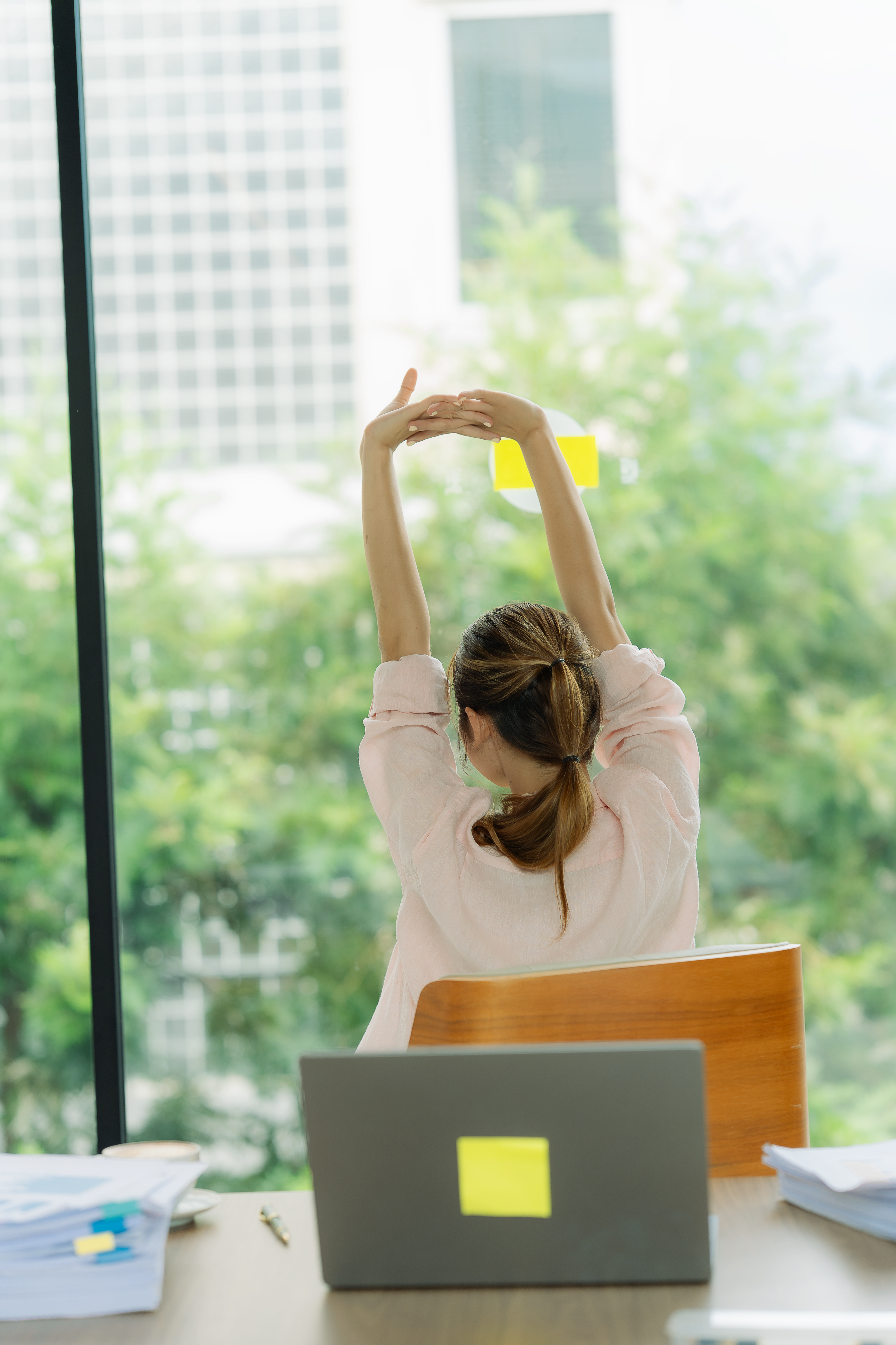 rear view of a young woman relaxing while stretchi 9d9abf368ac2381ff53d