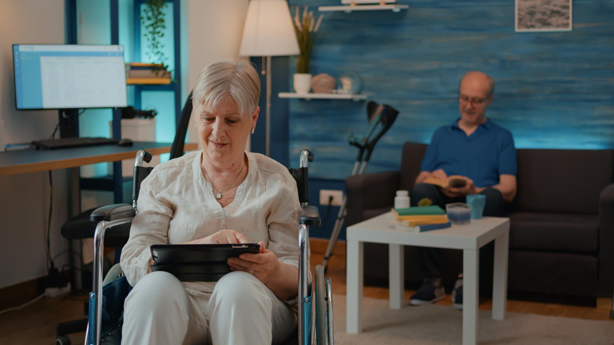 retired person using digital tablet and sitting in a62a629059a825e899e4
