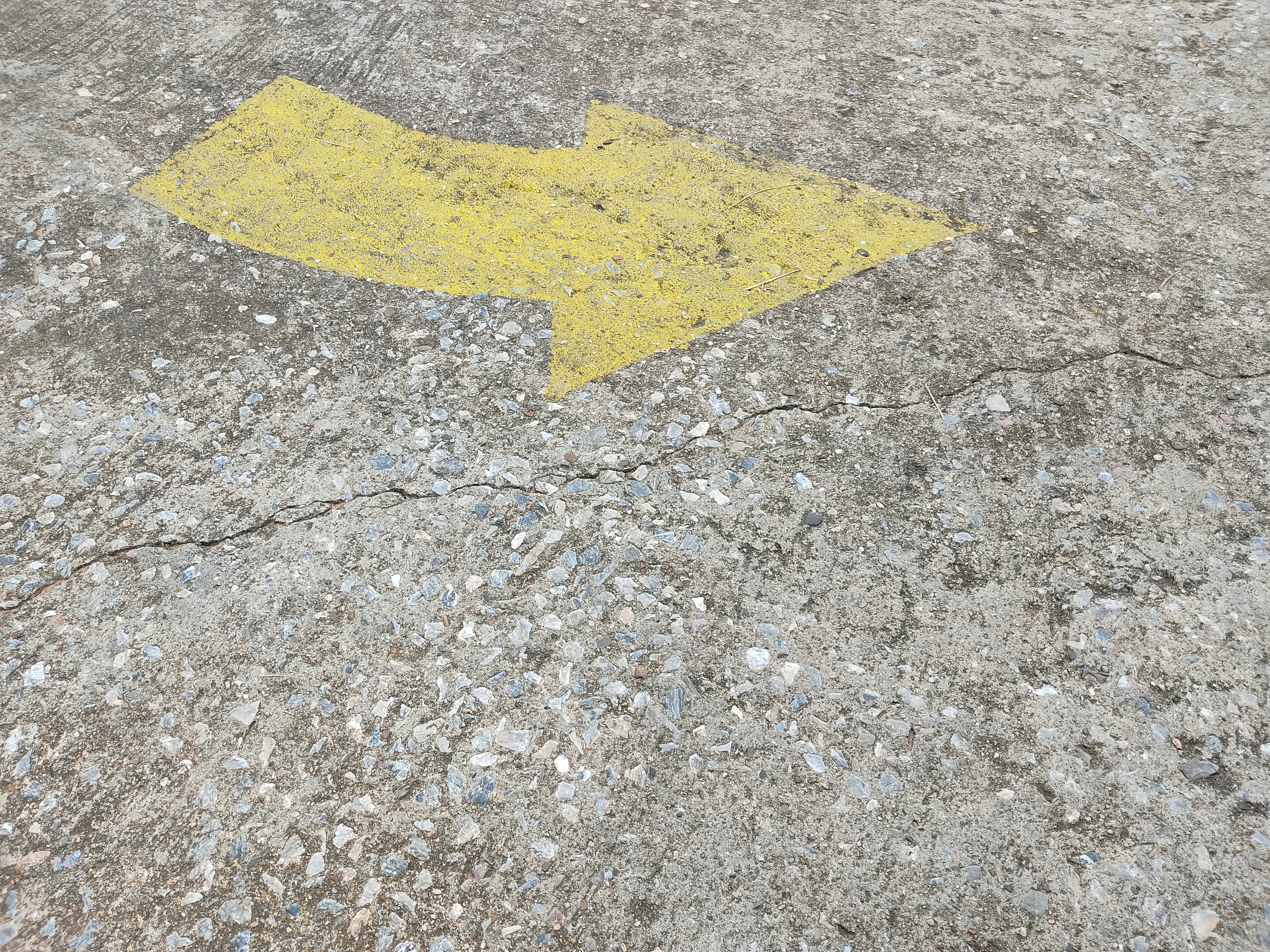 alt="concrete cracks and damage on concrete road"