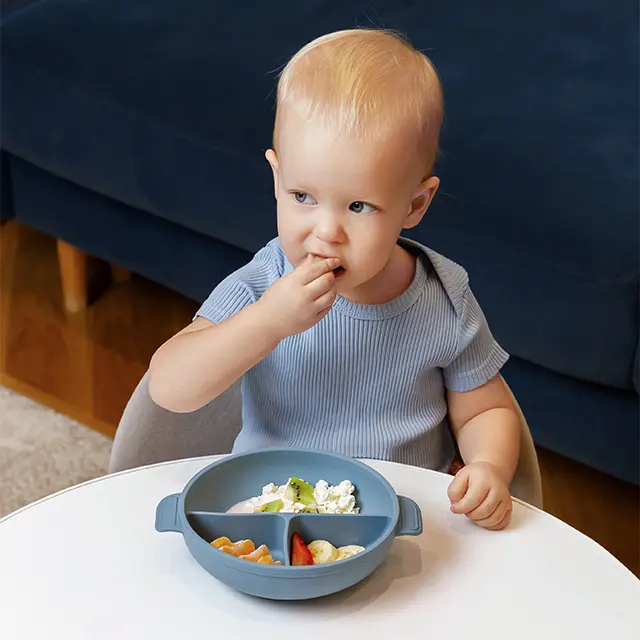 Baby eating from silicone plate