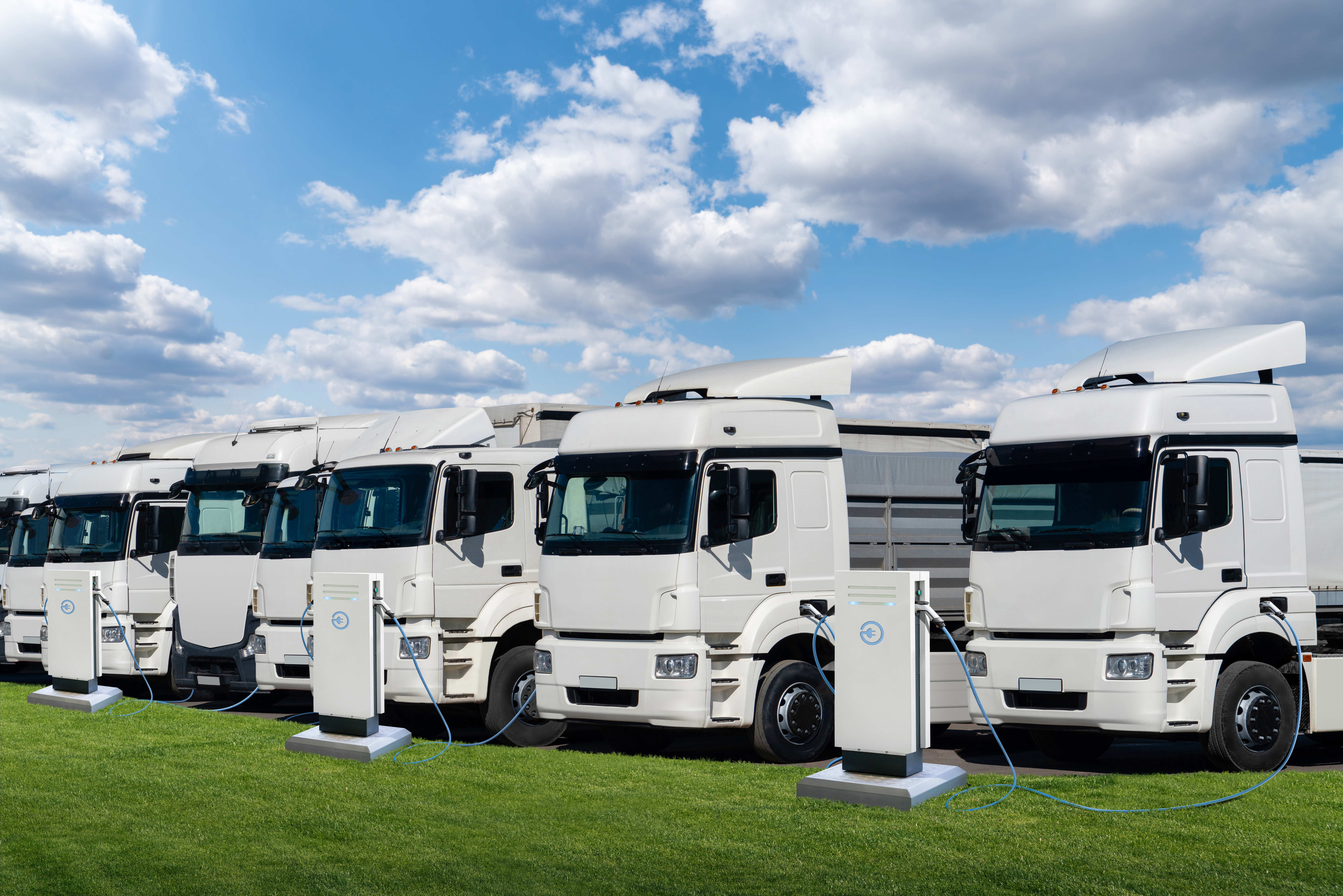 row of electric semi trucks at charging stations c944188476a9c74215a3