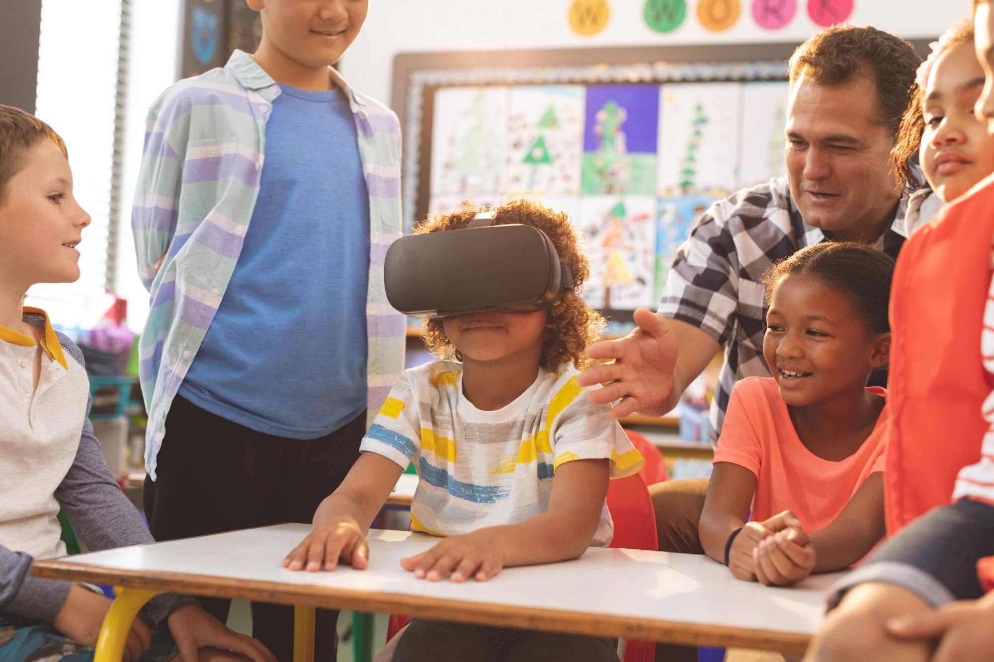 schoolboy using virtual reality headset with his c 956fb500c55d140b39ad