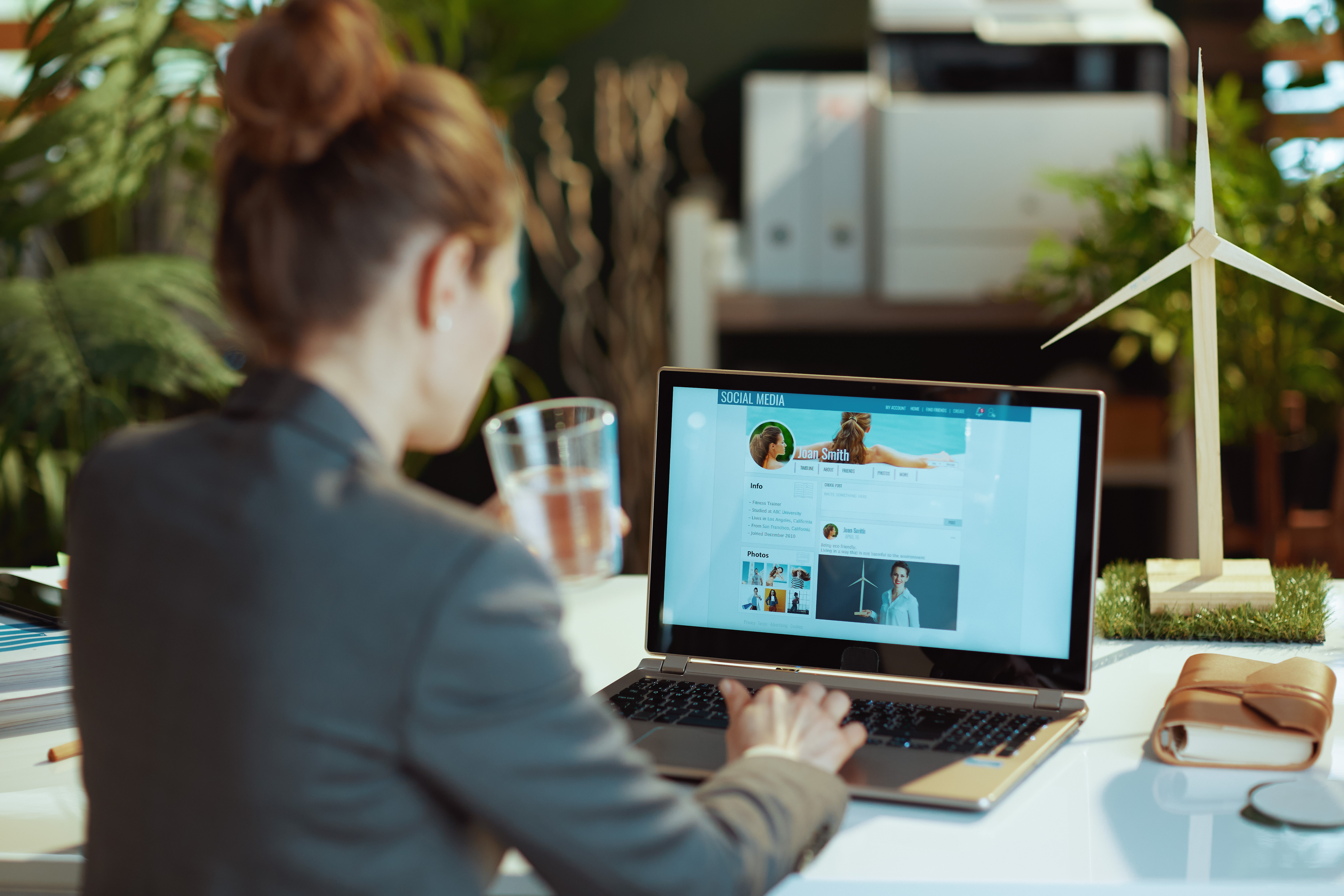 seen from behind modern woman reading news on soci bd1a64114d12682965e7