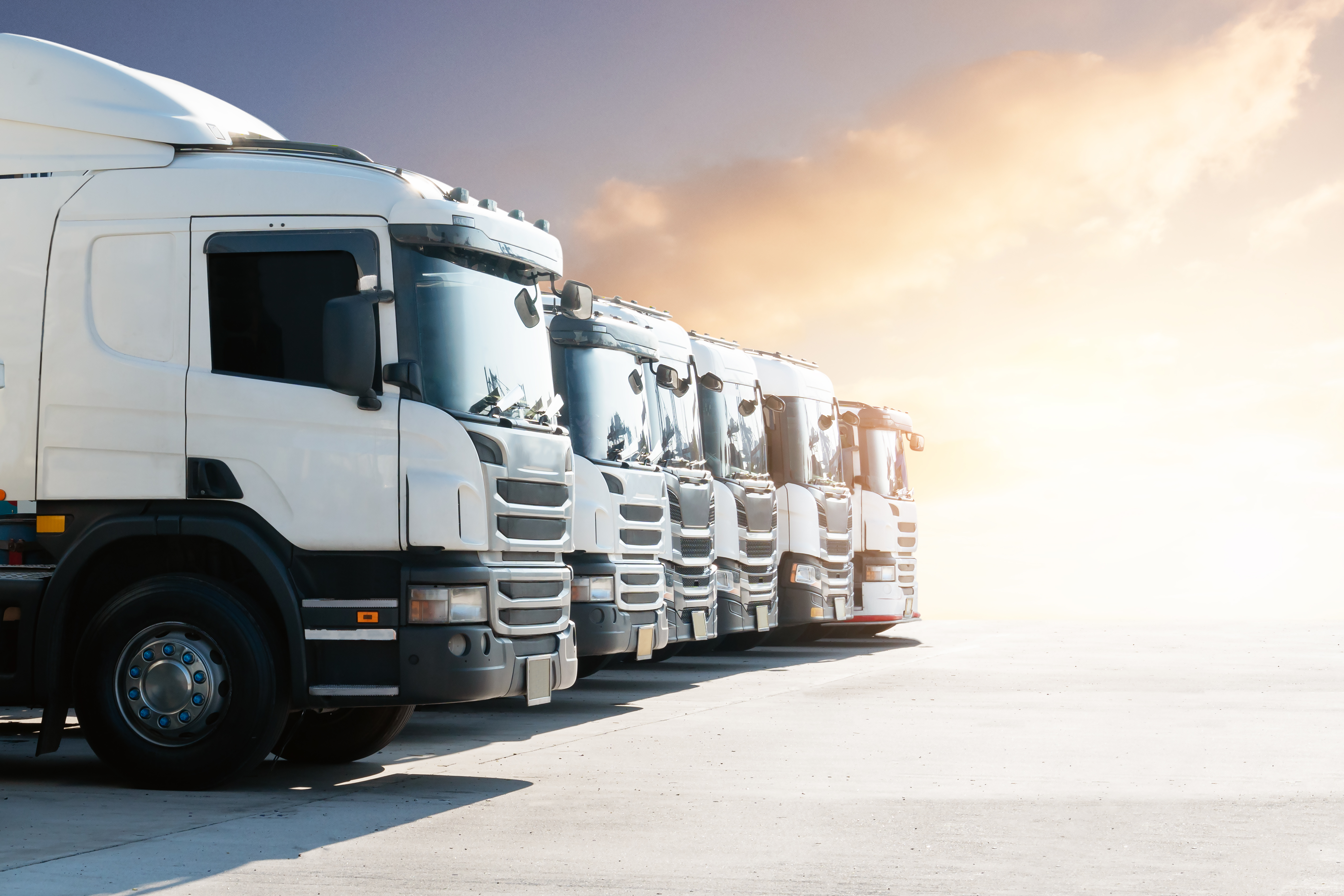 semi trucks on the parking lot at sunset sky big 4a4a559571648a6a49f9