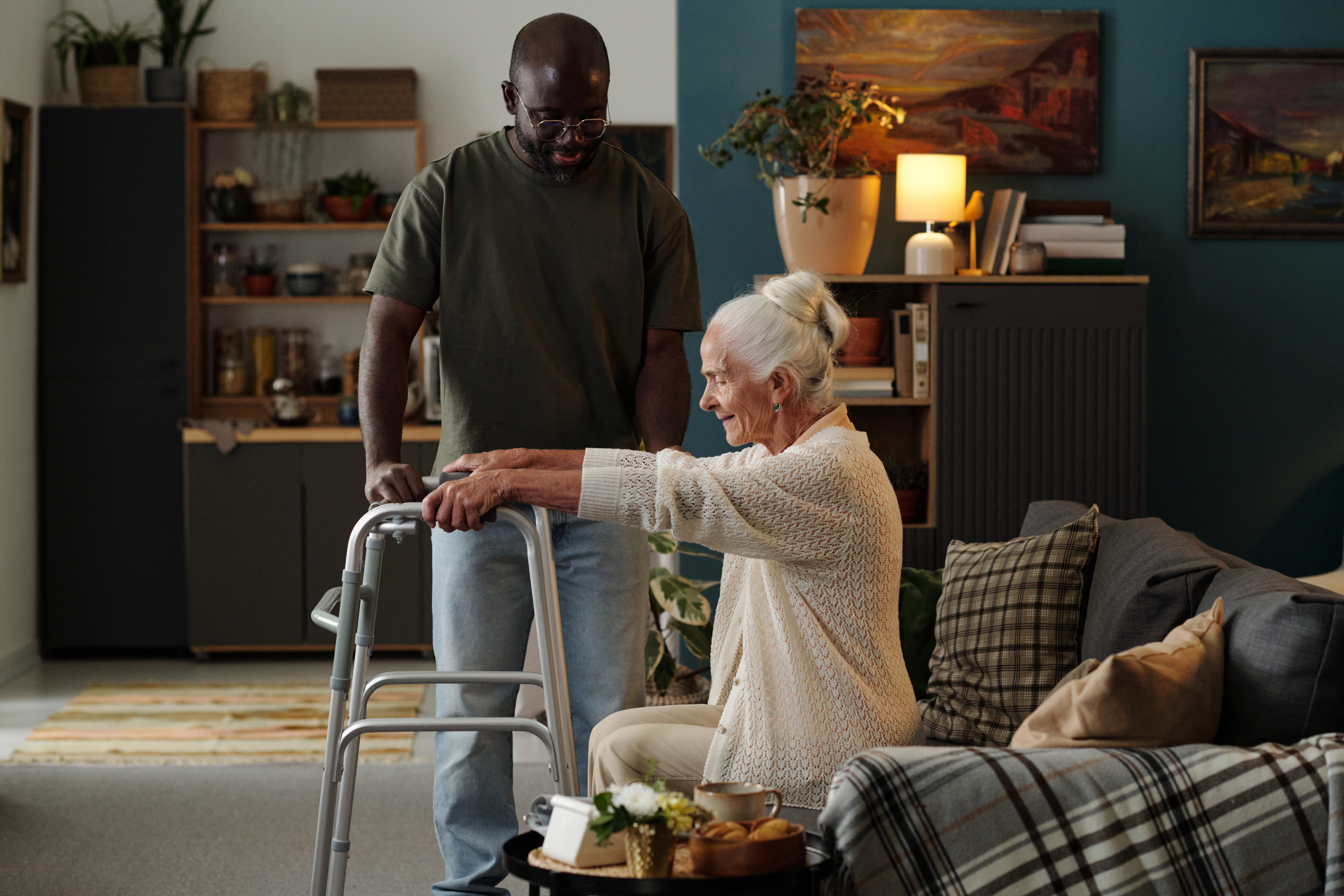 senior caucasian woman using walker assisted by bl d18b5a506312d6e6466d