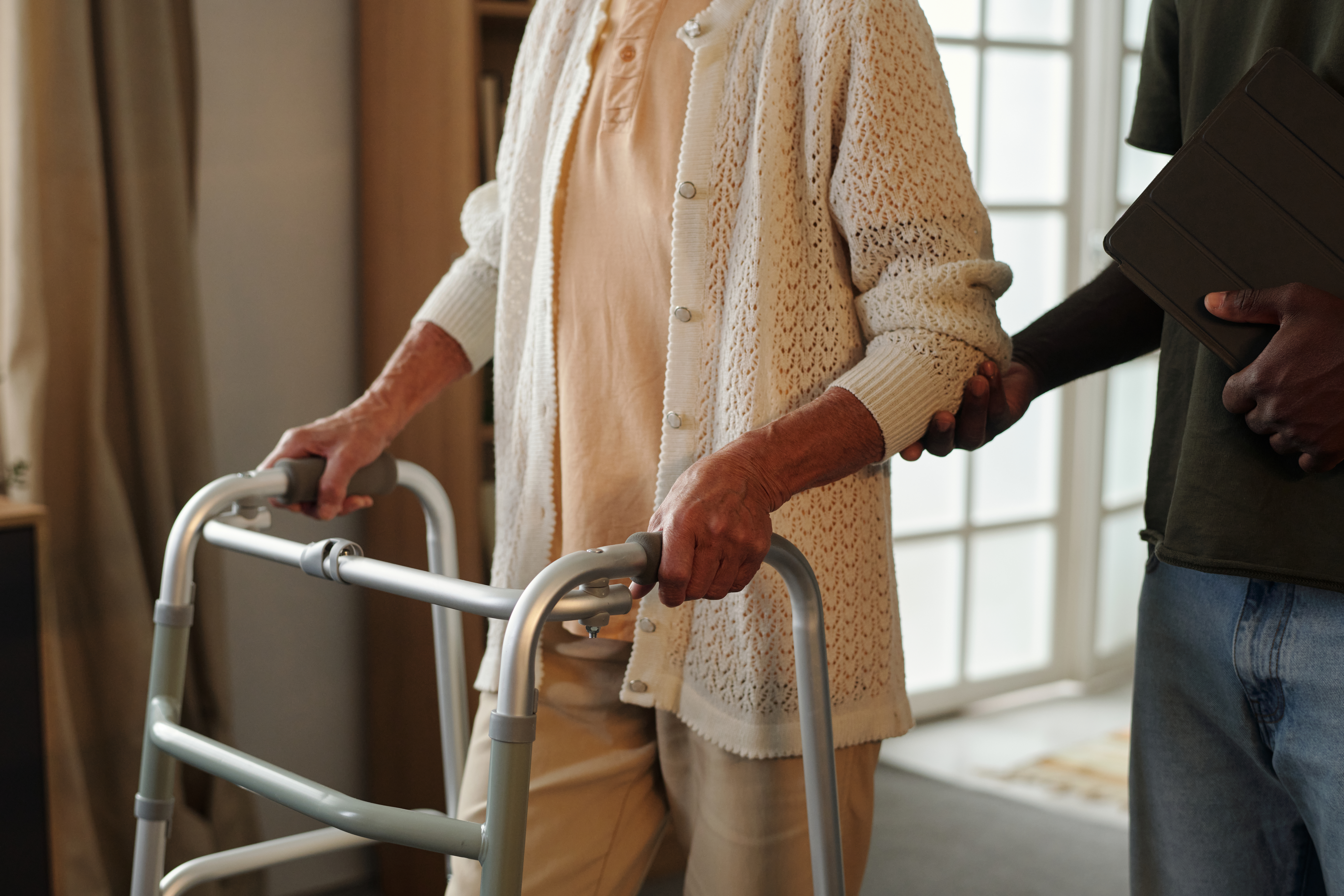 senior caucasian woman using walker assisted by yo c95f58529d2a29b466bb