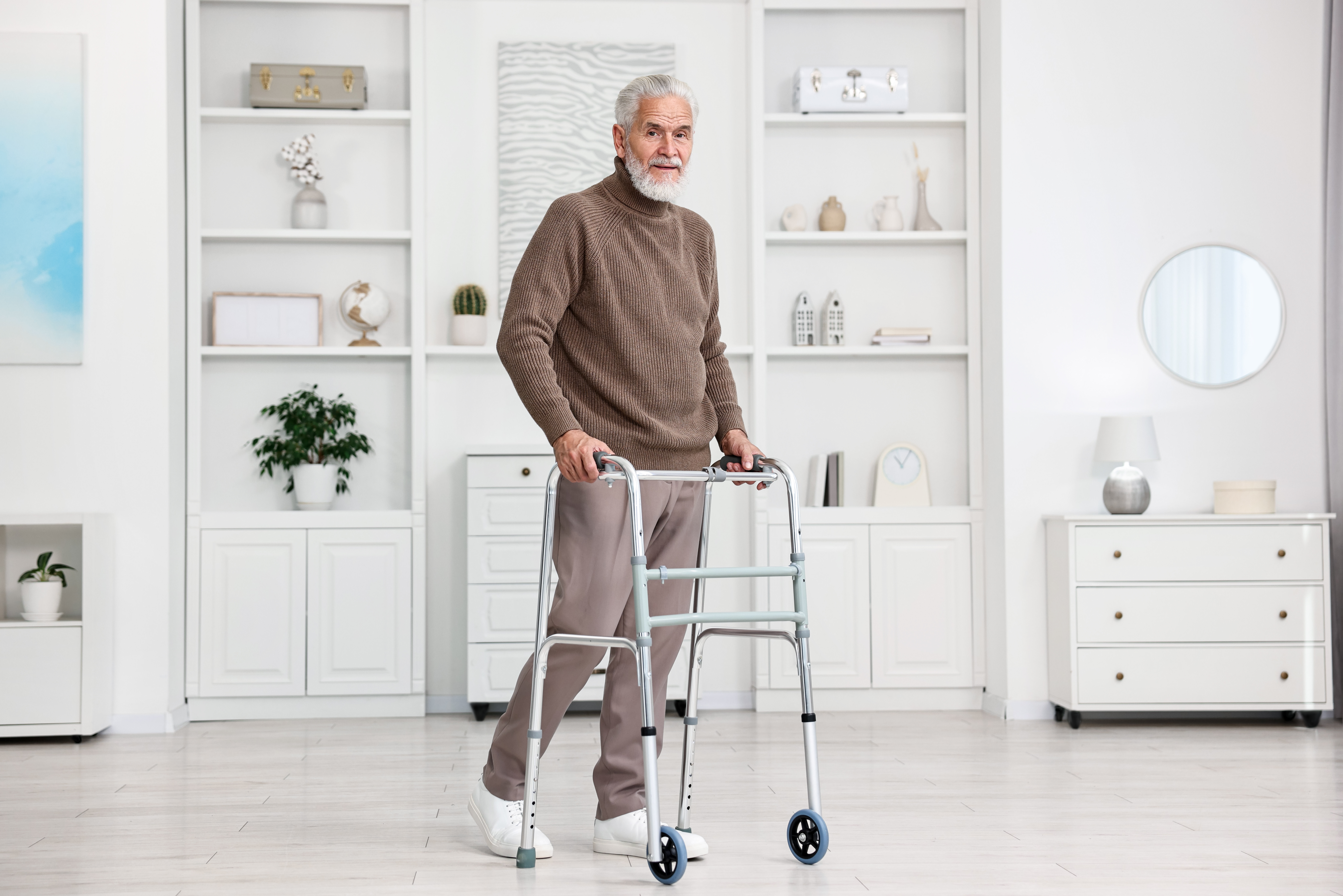senior man using walking frame at home df53e4a68af1d9487840