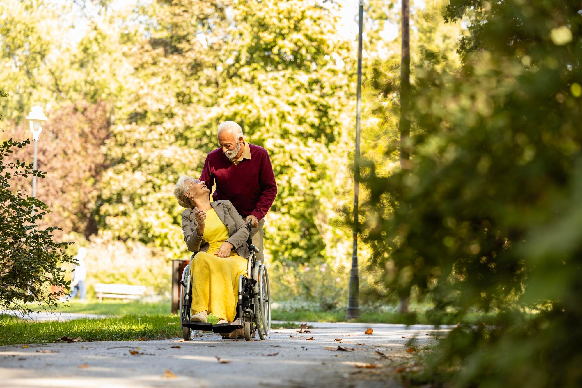 senior man with his wife in wheelchair going for a 1e0dfac618d98660c358