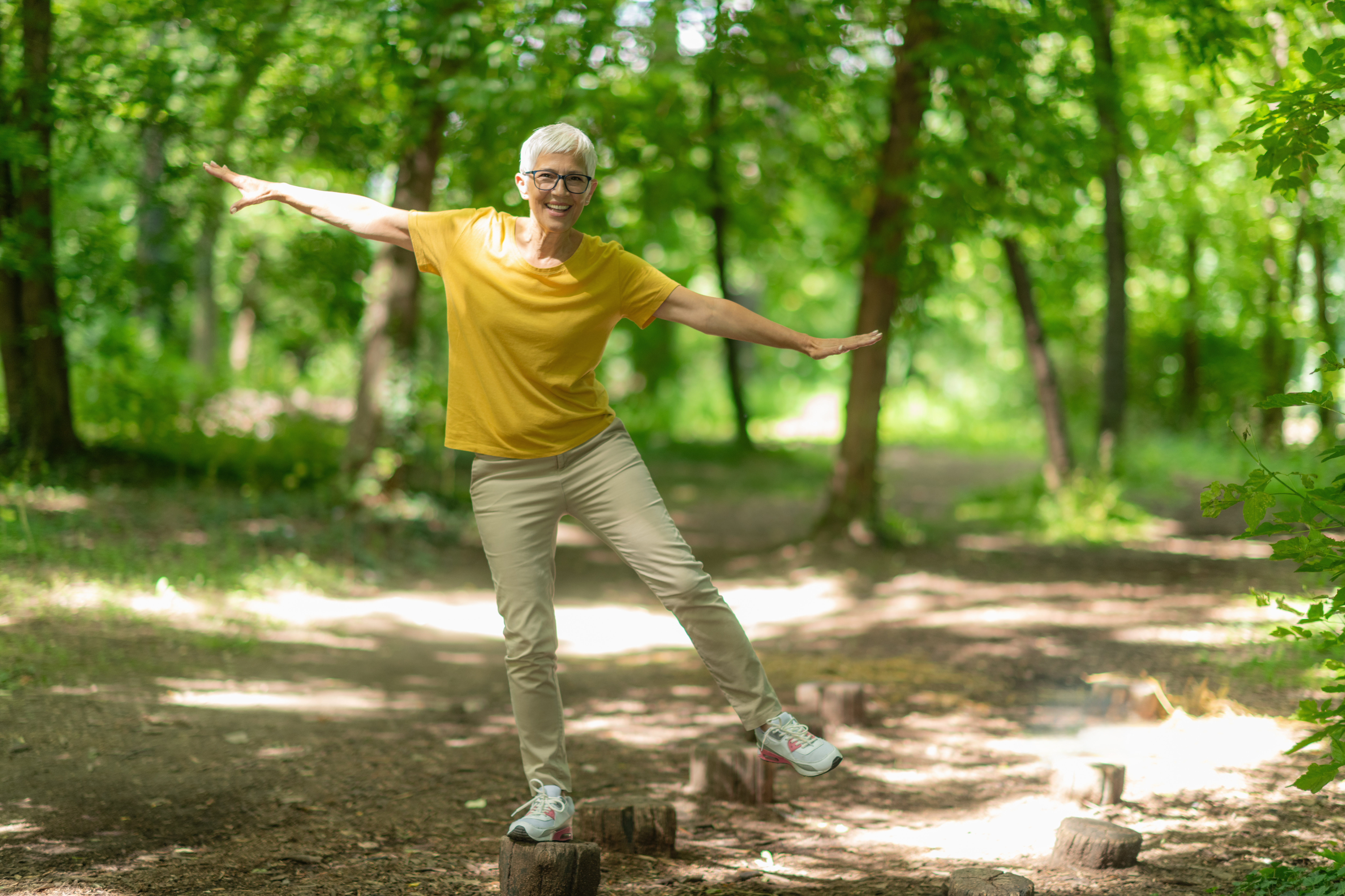 senior woman doing balance exercises in the park f 3aab2dd34af8e8cd752f