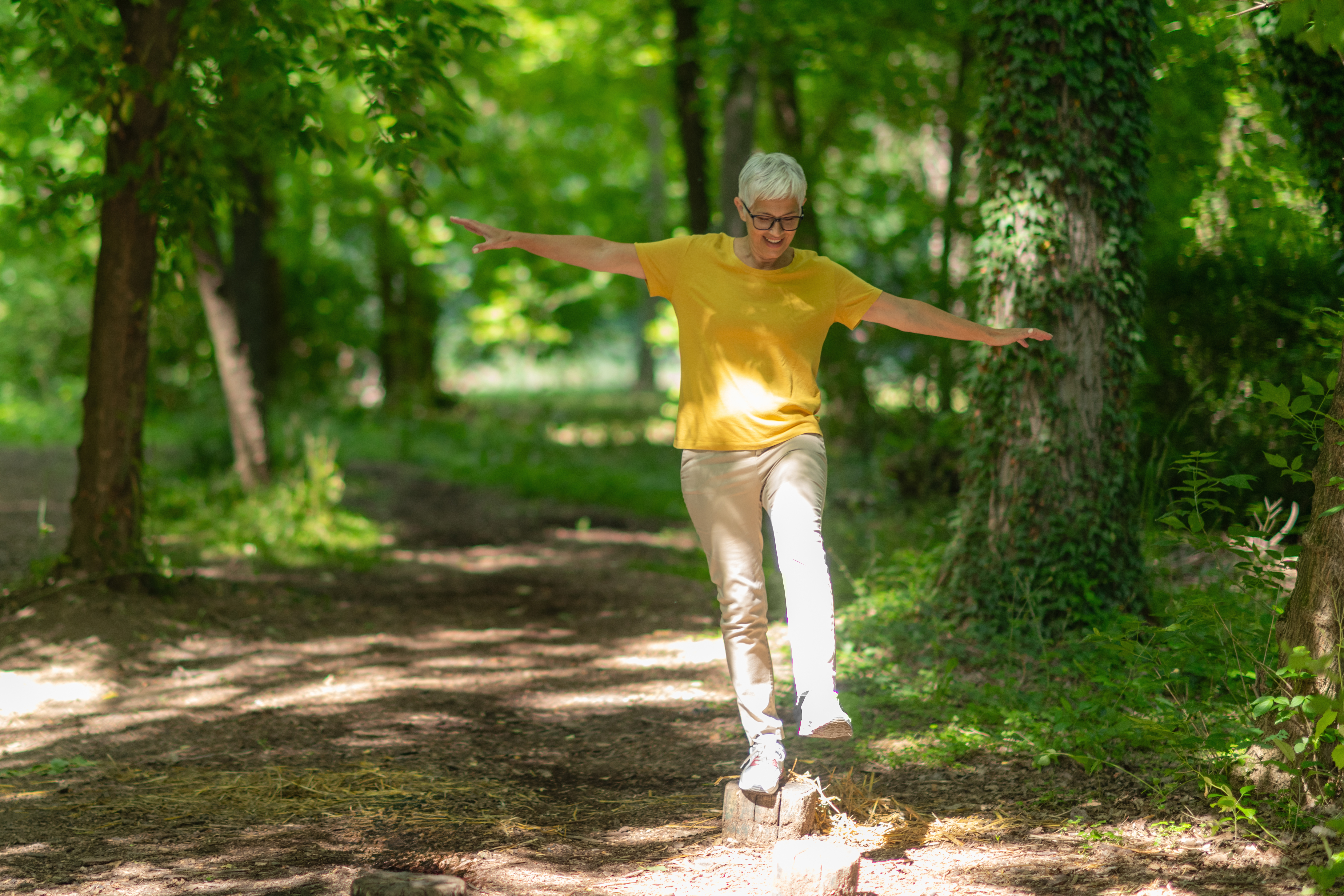 senior woman doing balance exercises in the park t 2d5c05c172d692a840b1