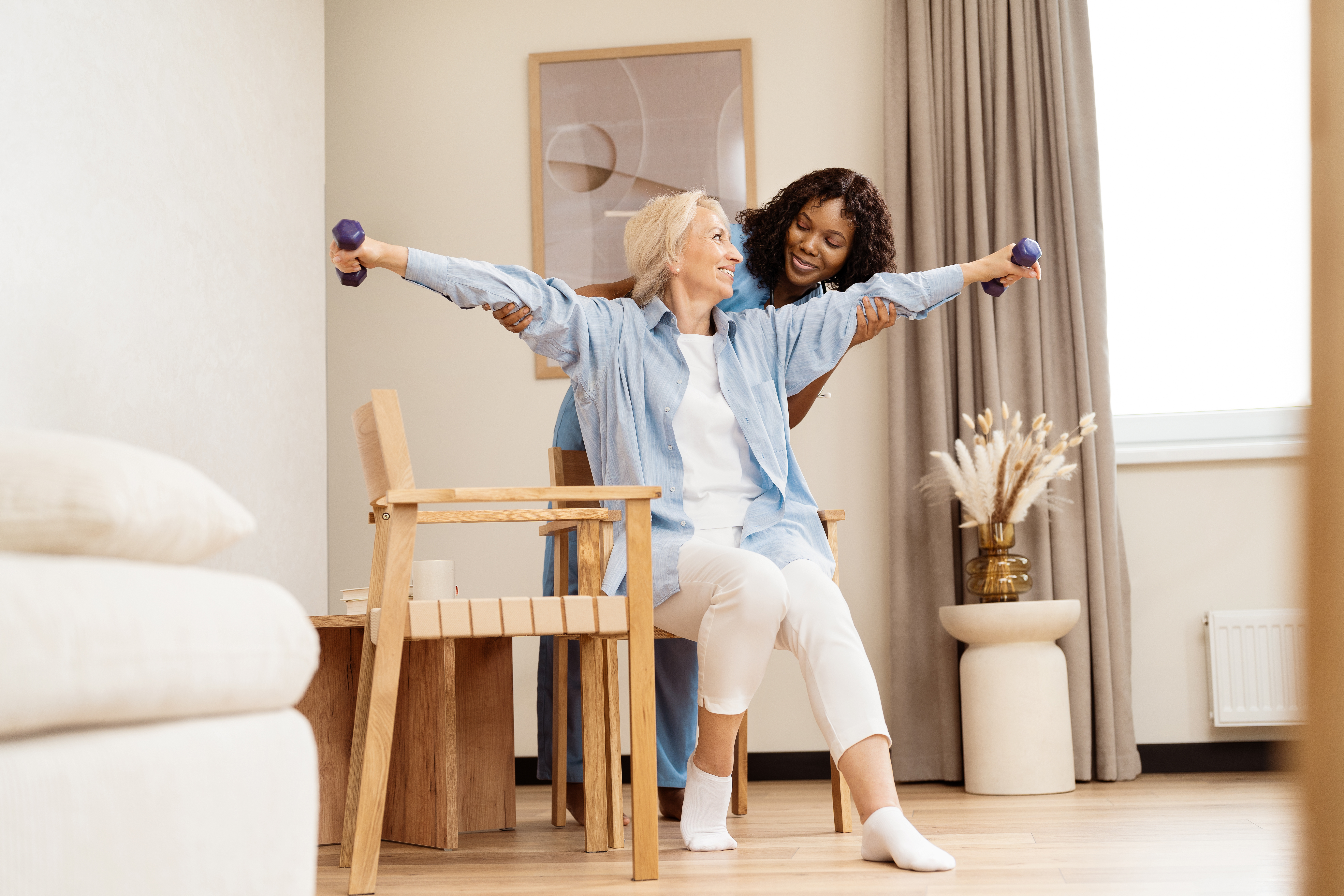 senior woman exercising with physiotherapist at ho 797a9fe03eefacf9e43b