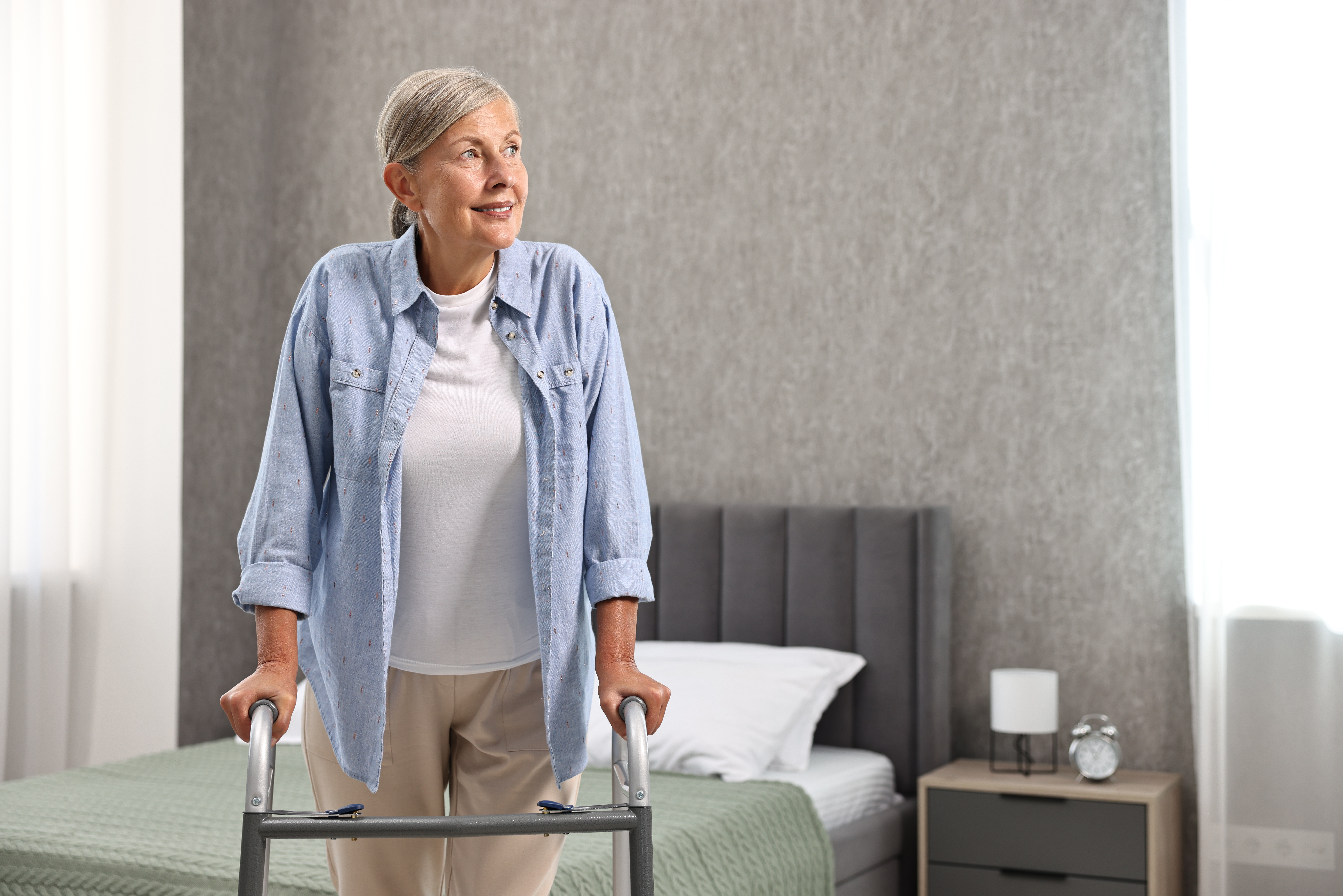 senior woman with walking frame at home 8ed4ae1c47499a99fc0f