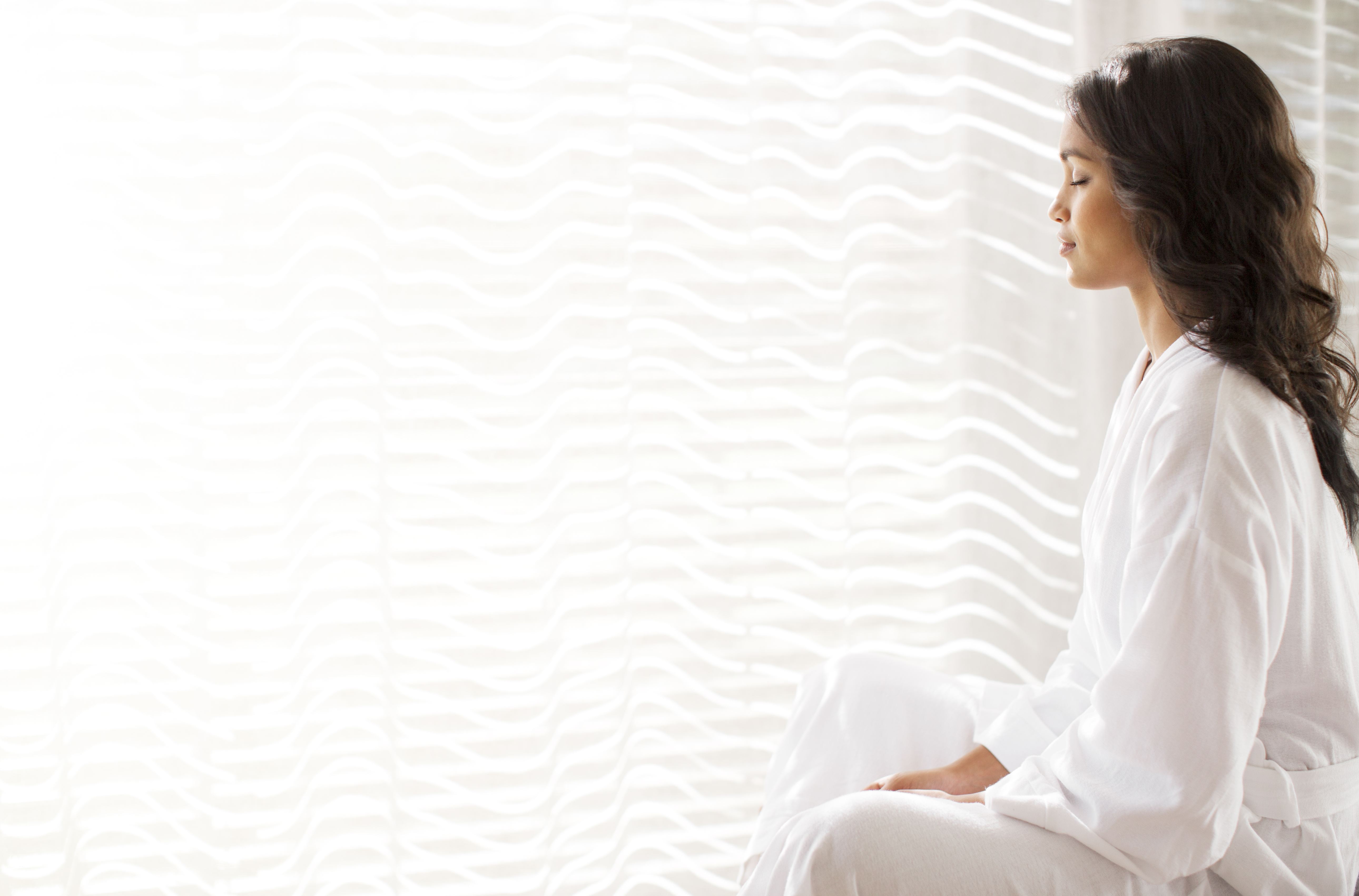 serene woman in bathrobe meditating at sunny windo e0b90407b0b19ffee108