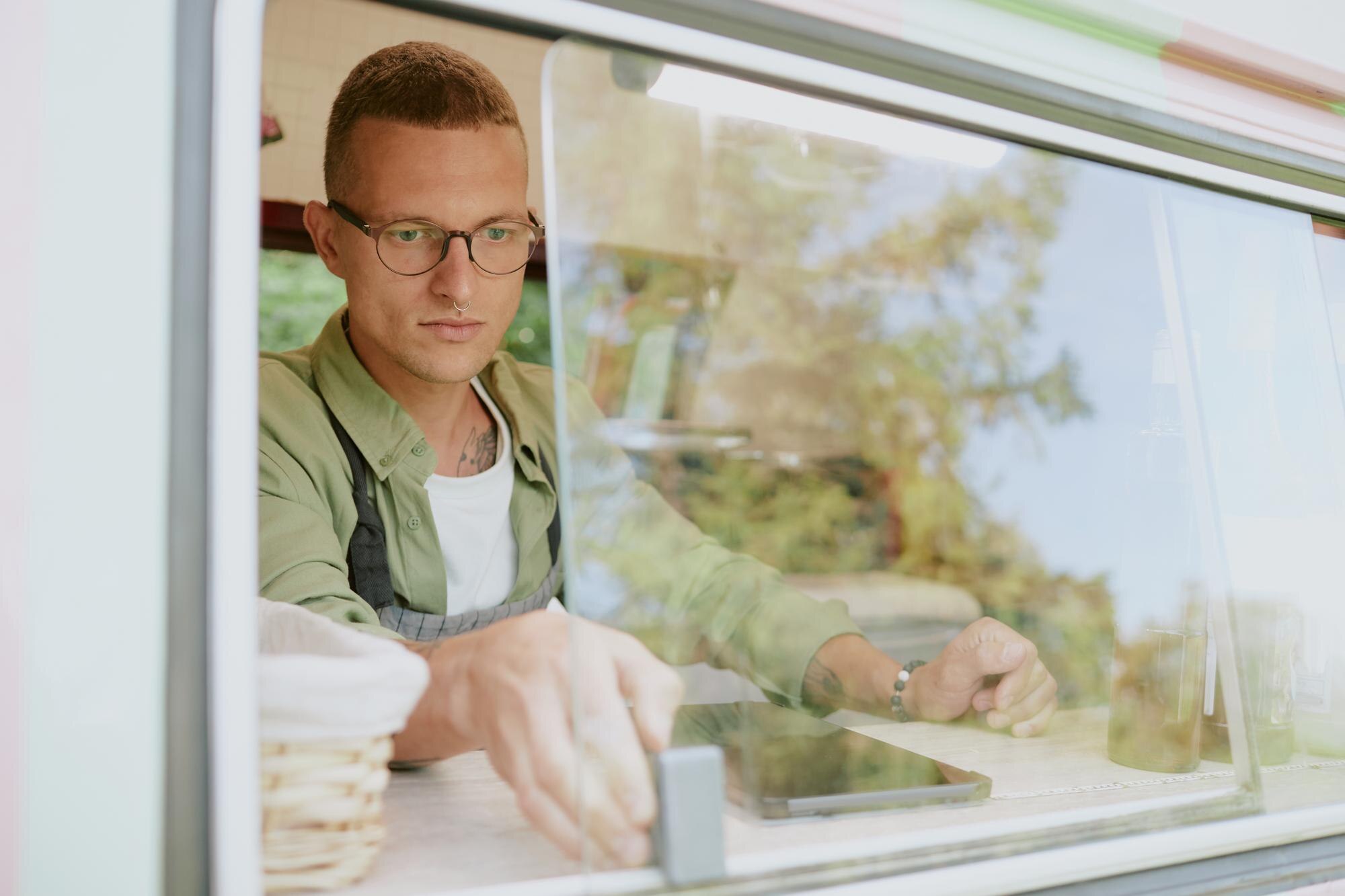 Buy cheap, buy twice: The real cost of poor‑quality plastics in fabrication 2 serious food truck worker opening window ad2fd8d75fa3820cbd9c