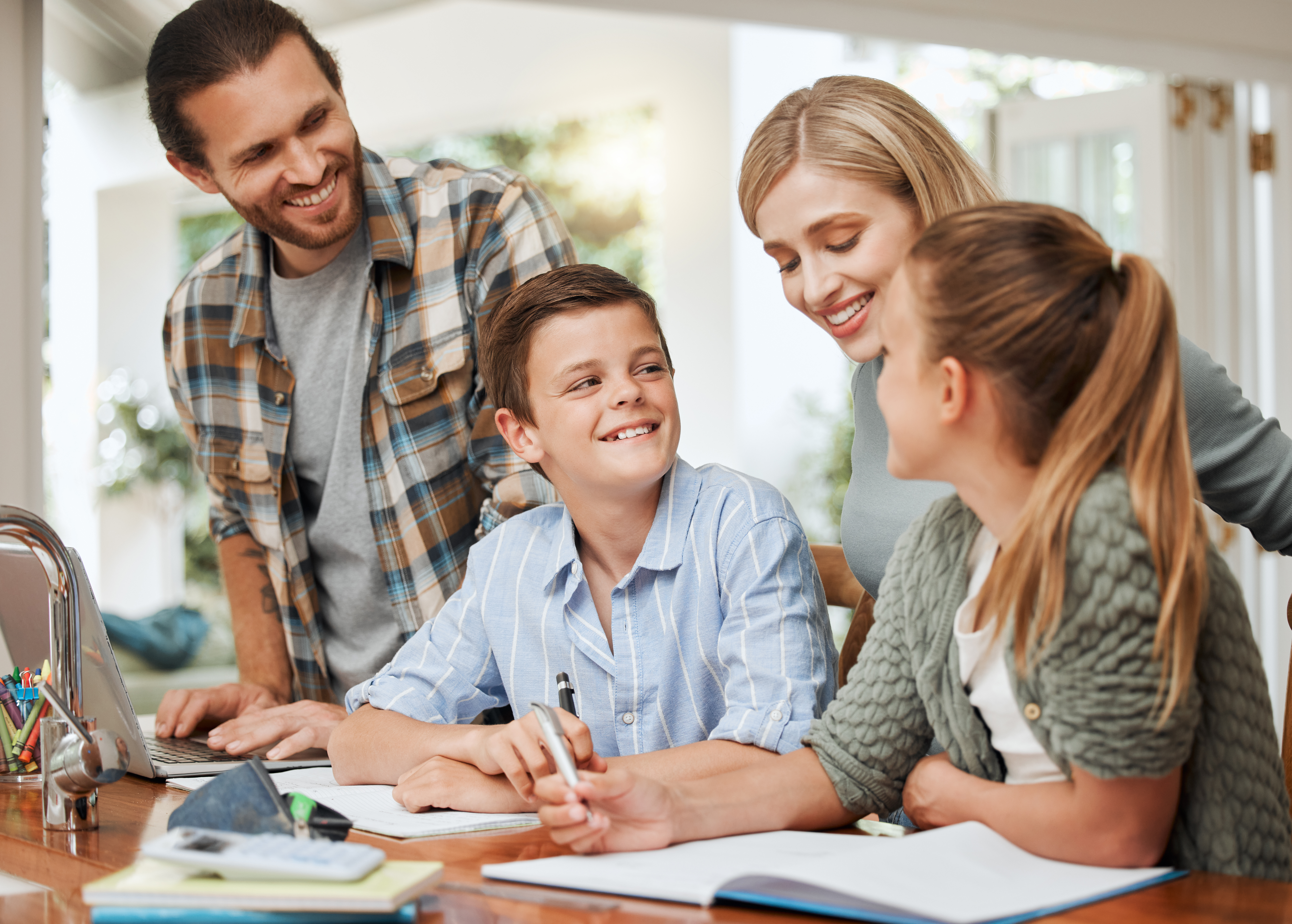 Shot Of A Young Family Doing Homework Together At Db63bf437202e6c11818