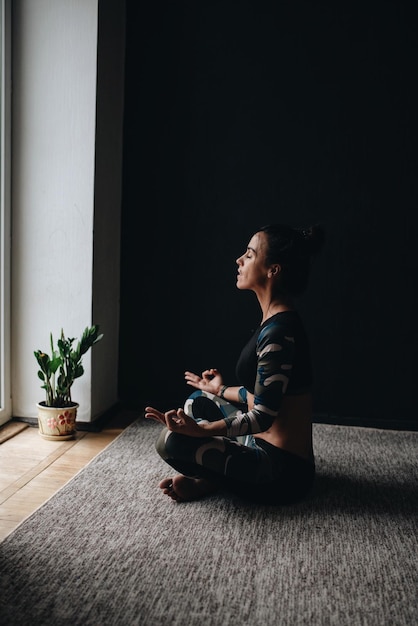 Side View Of Woman Meditating In Lotus Position At 92Dc9Cbfbd3Aa7610Ff7
