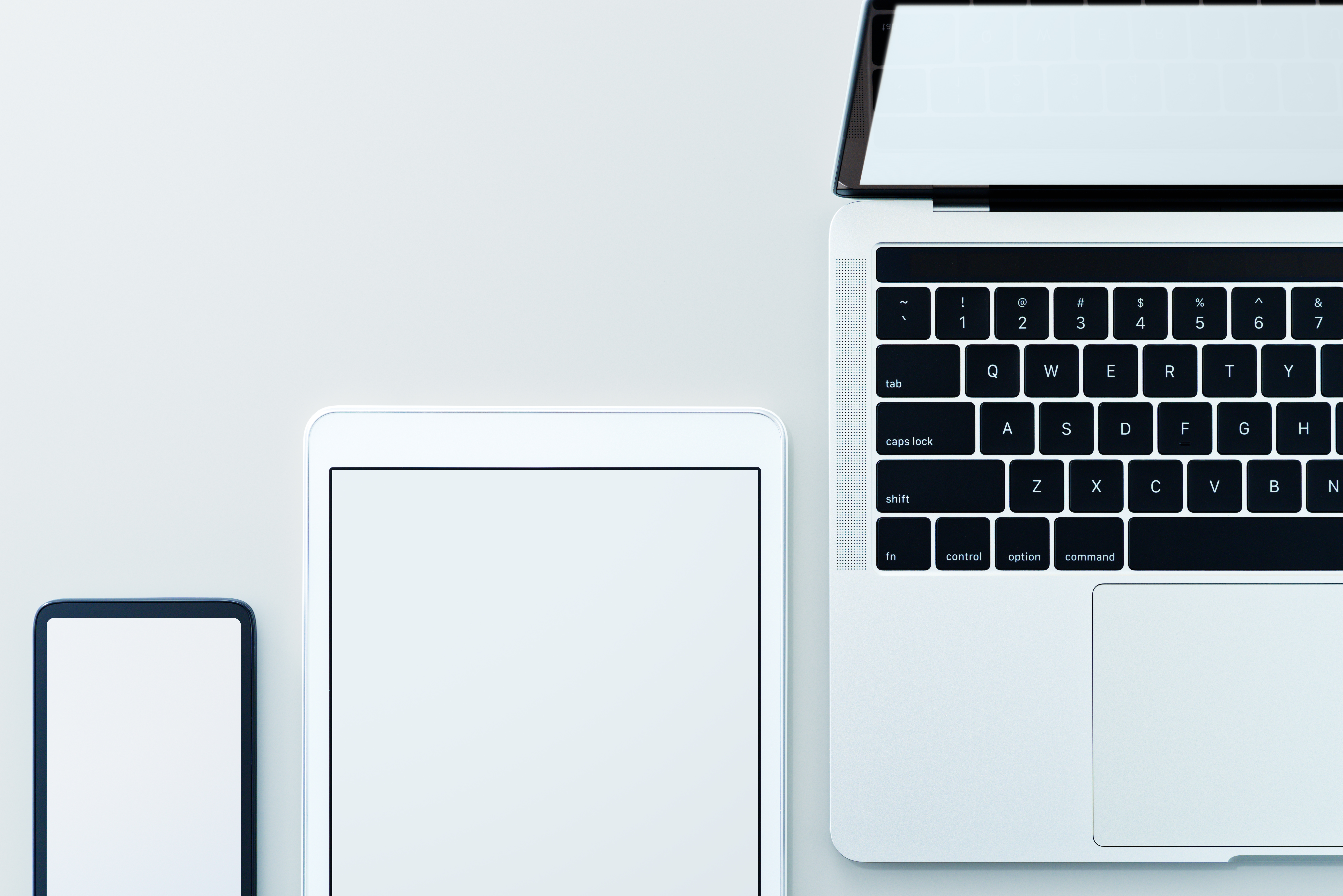 Unlock the Potential of Integrated Branding and Digital Solutions with Defyn Digital 58 smartphone tablet computer and laptop on gray bac ac7d43113defeb0490d4