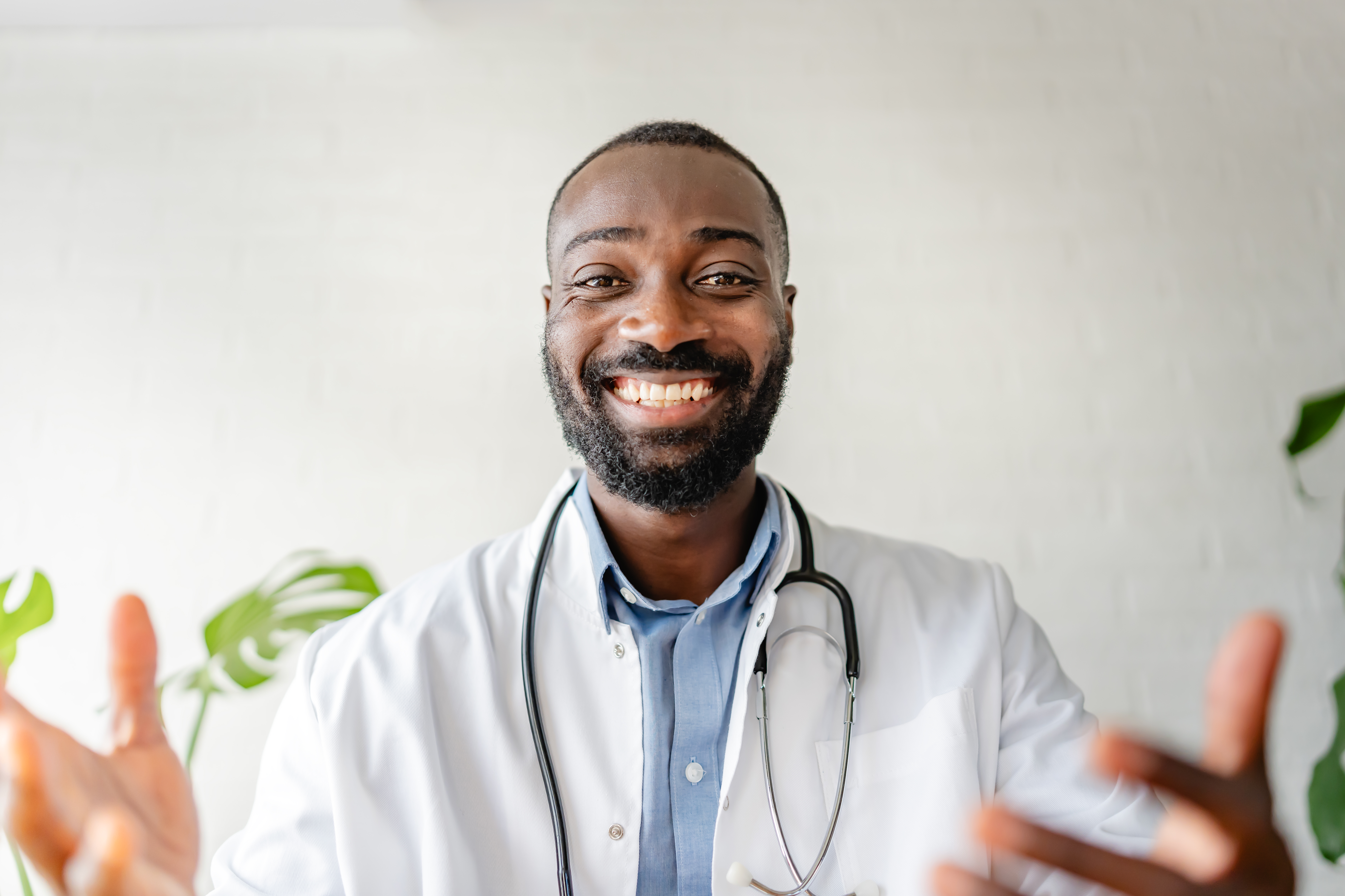 smiling african american doctor having an online c 7a34b2fd5e783aaebedc