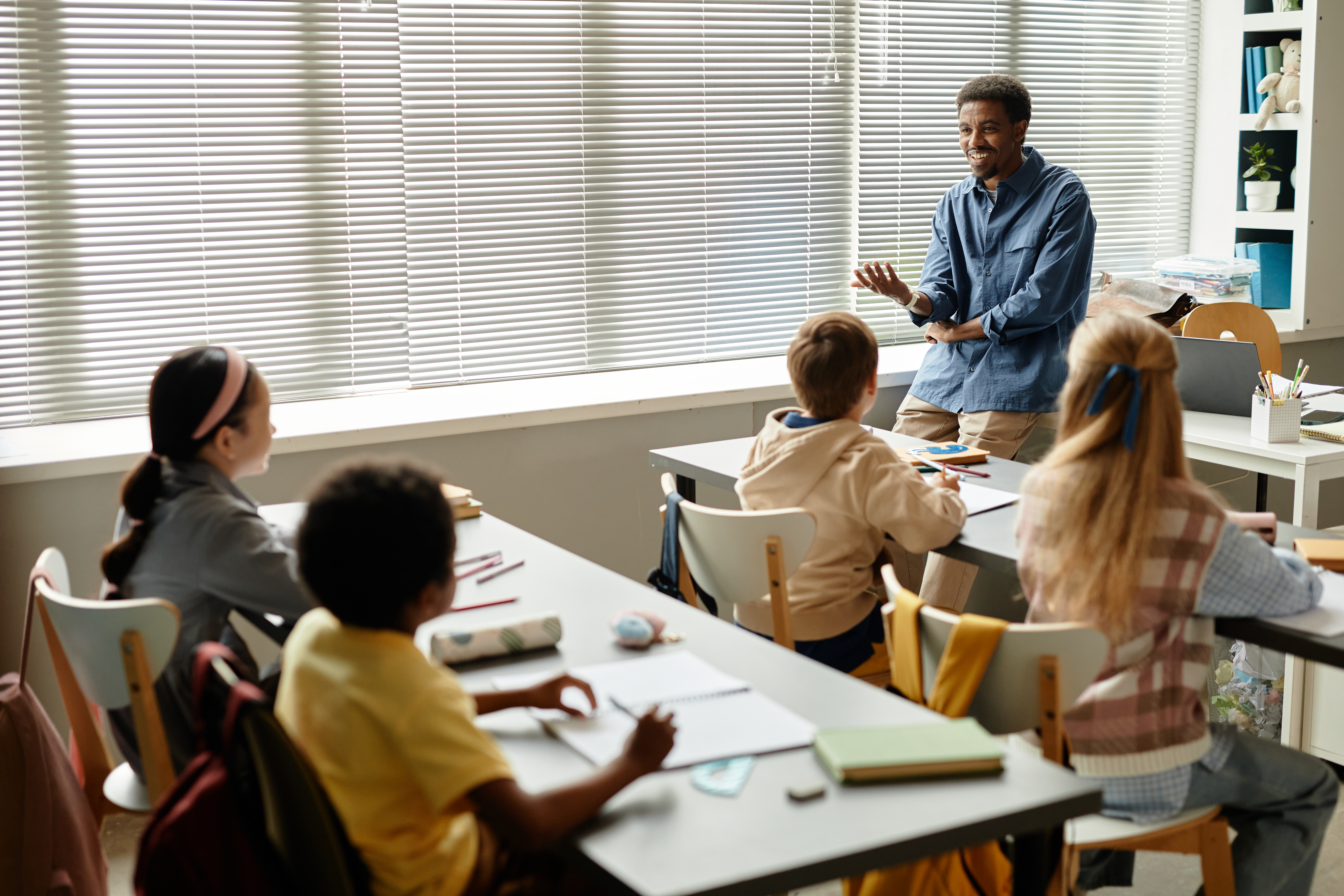 Smiling African American Teacher Talking To Childr 593e78cfb61c86b29d6c