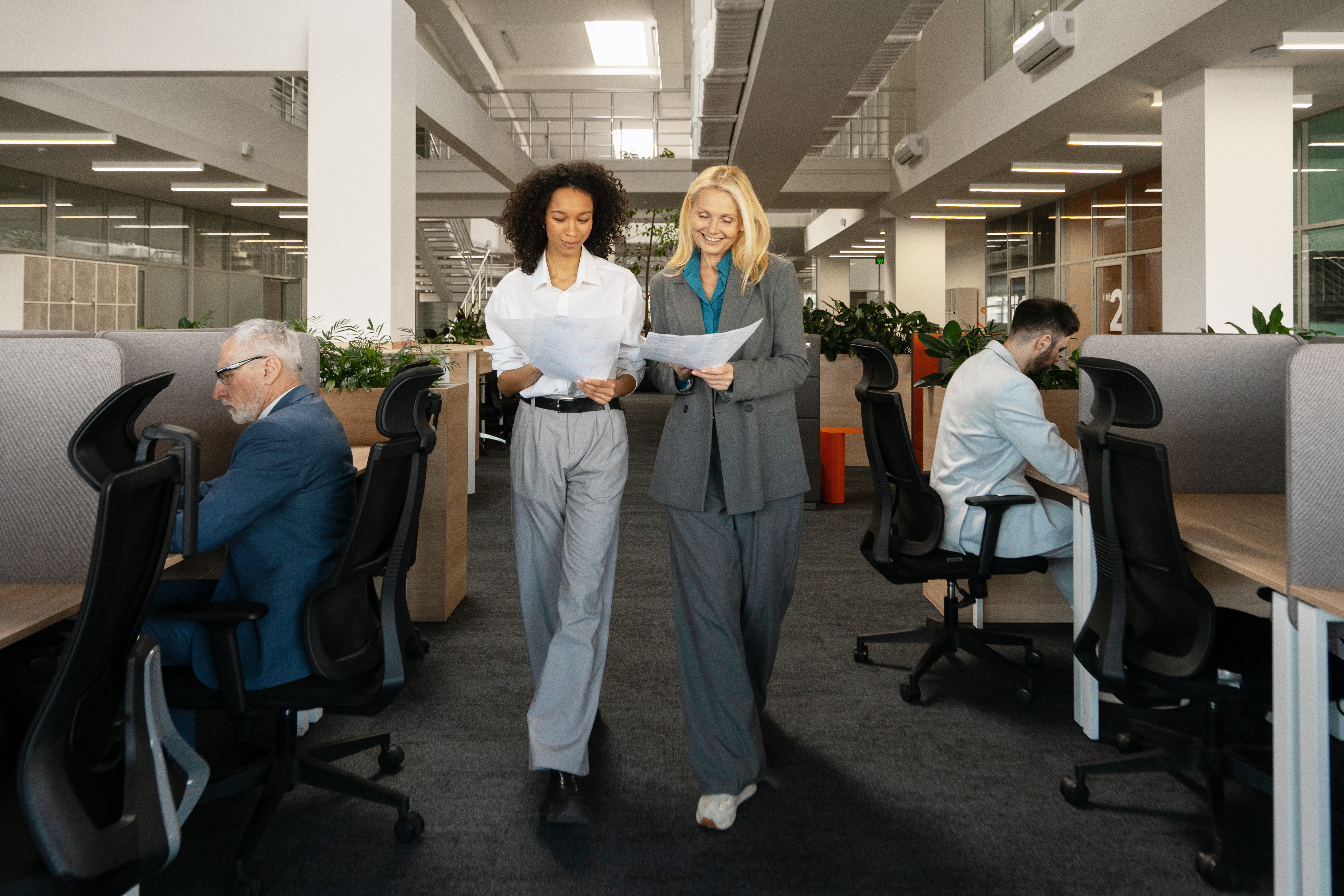 smiling beautiful businesswomen walking and discu e882f7ed29ebf4e6e380