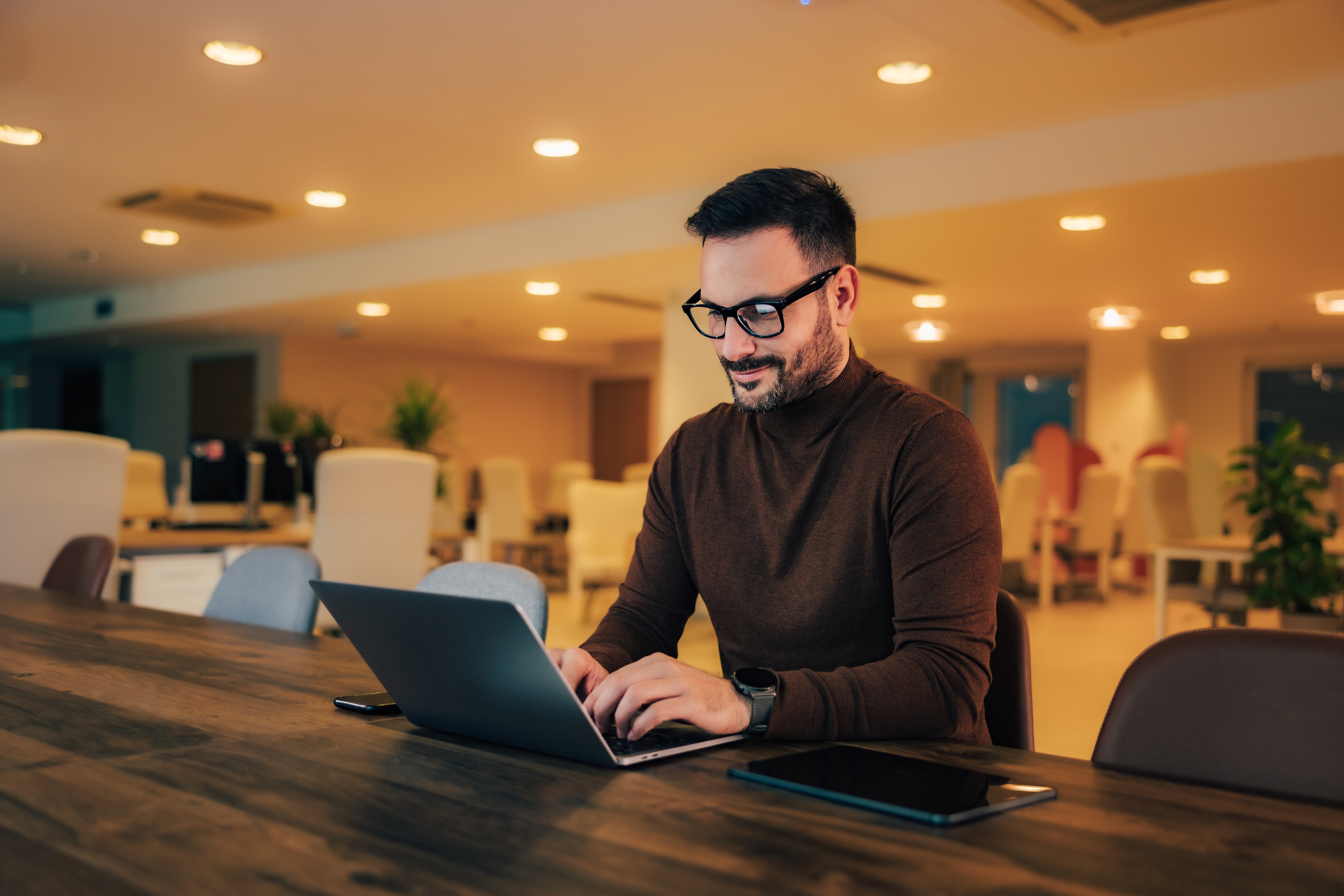 smiling businessman typing an e mail to clients ov 2fcd066a88220e30e814