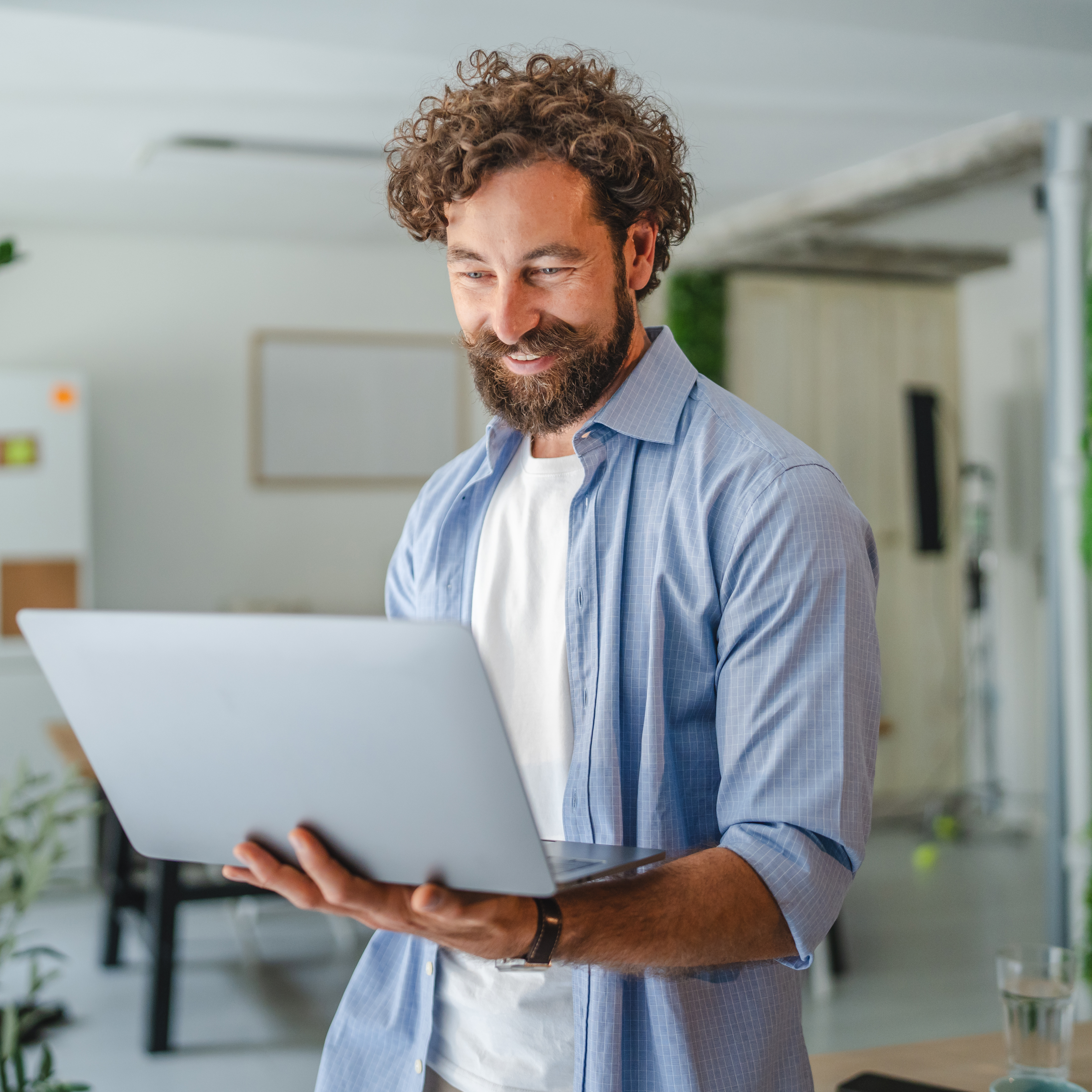 smiling businessman working on laptop in modern of c33ffd38669726219dee