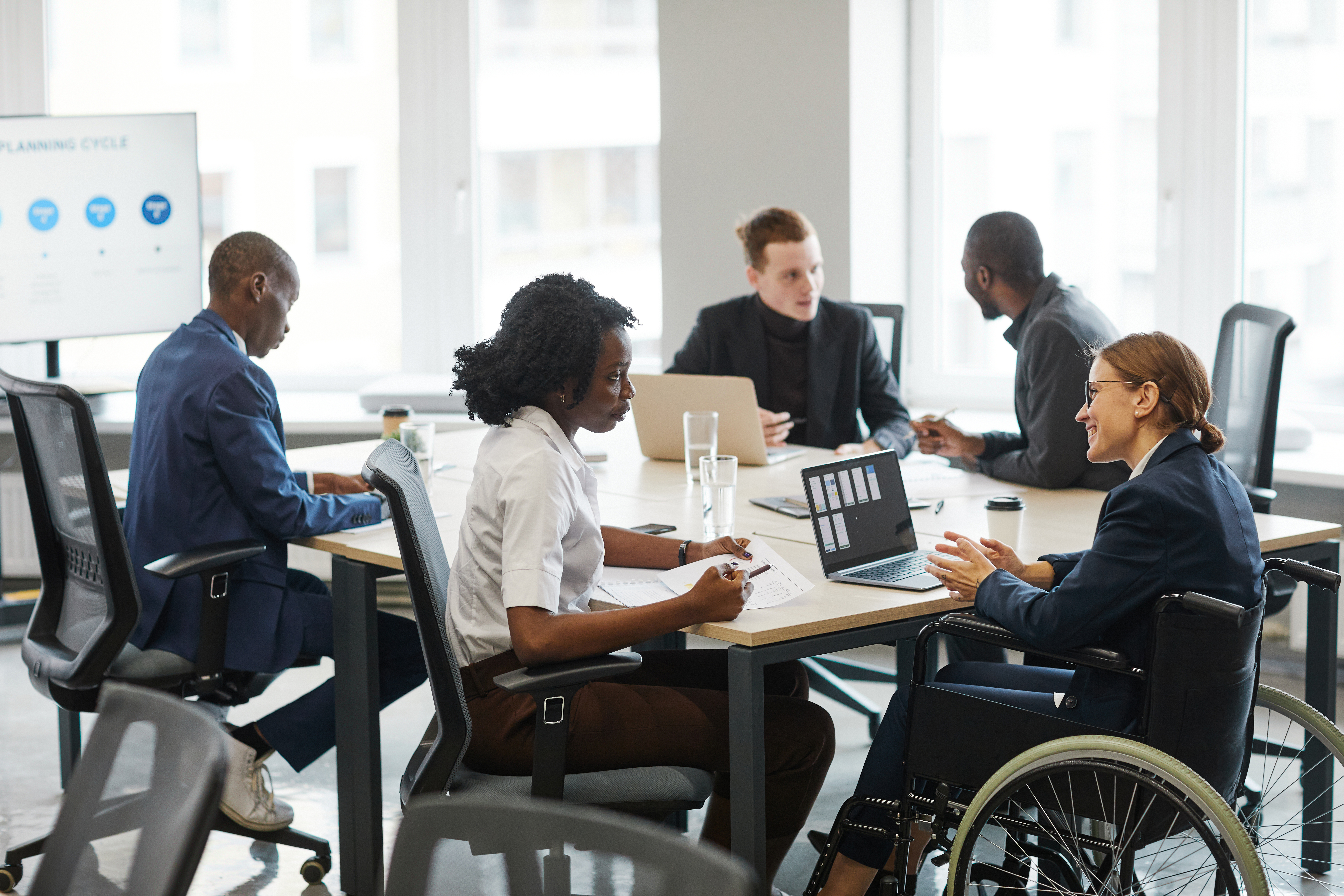 smiling businesswoman using wheelchair in meeting b8fc2ad687fdcb99fcf9
