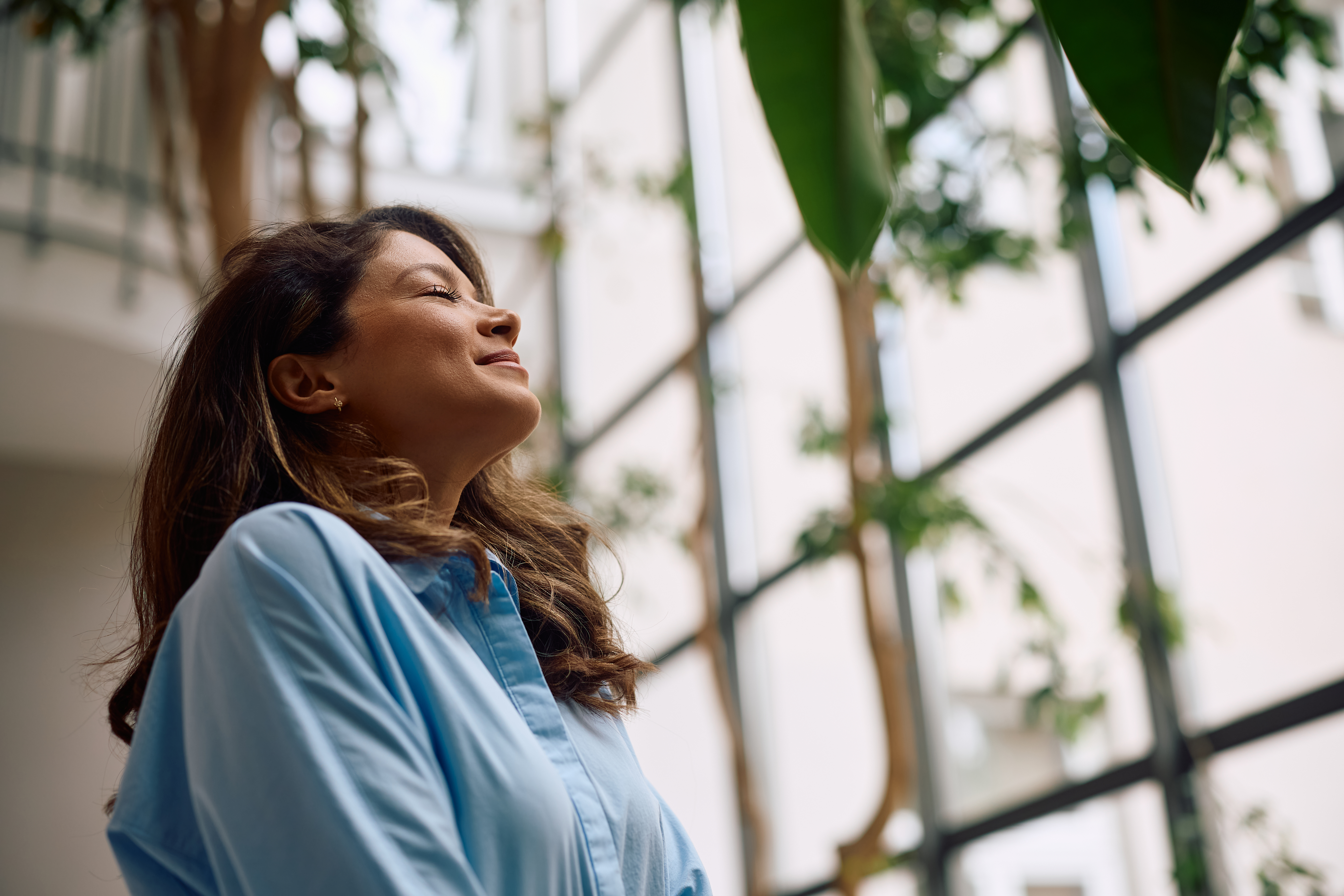 smiling businesswoman with eyes closed at casual o 6d0ec8e89243787145ec