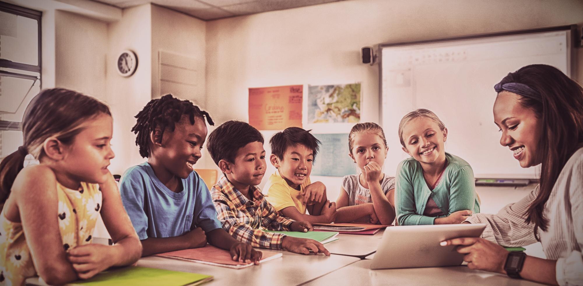 Smiling Teacher Giving Lesson With Tablet Computer D0acfd357ca3ab0262ed