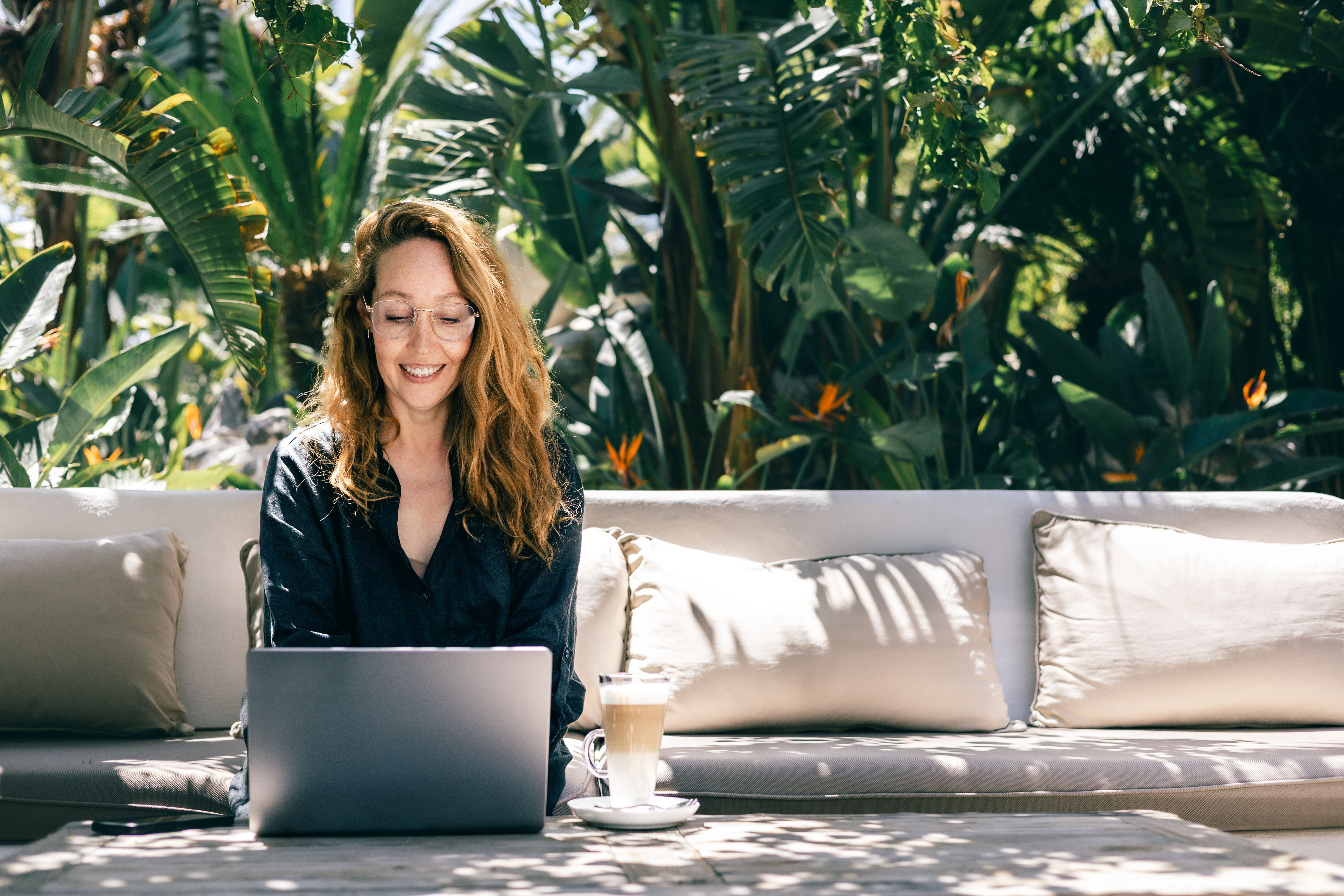 Building Your Dream Travel Career: Everything You Need to Know to Get Started 🌍✈️ 2 smiling woman working on laptop outdoors in tropic 19da8db0b2af63abb27b