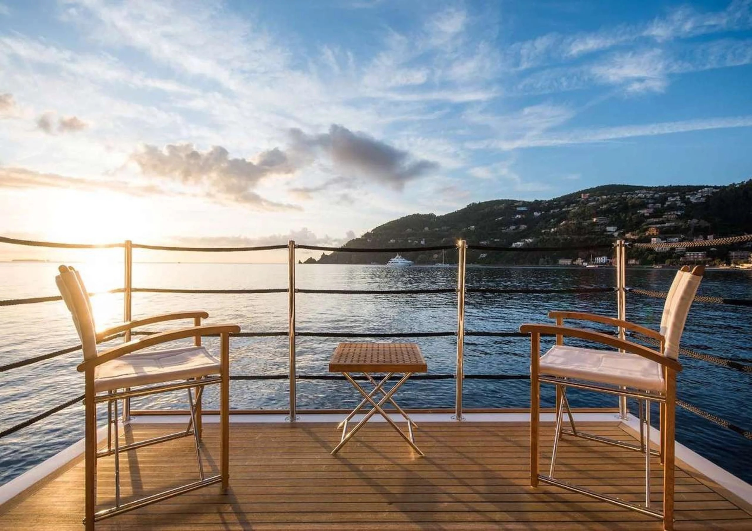 Side‑by‑side comparison of a luxury yacht deck and a beachfront resort pool, illustrating the unique advantages of a yacht charter over a traditional resort stay.