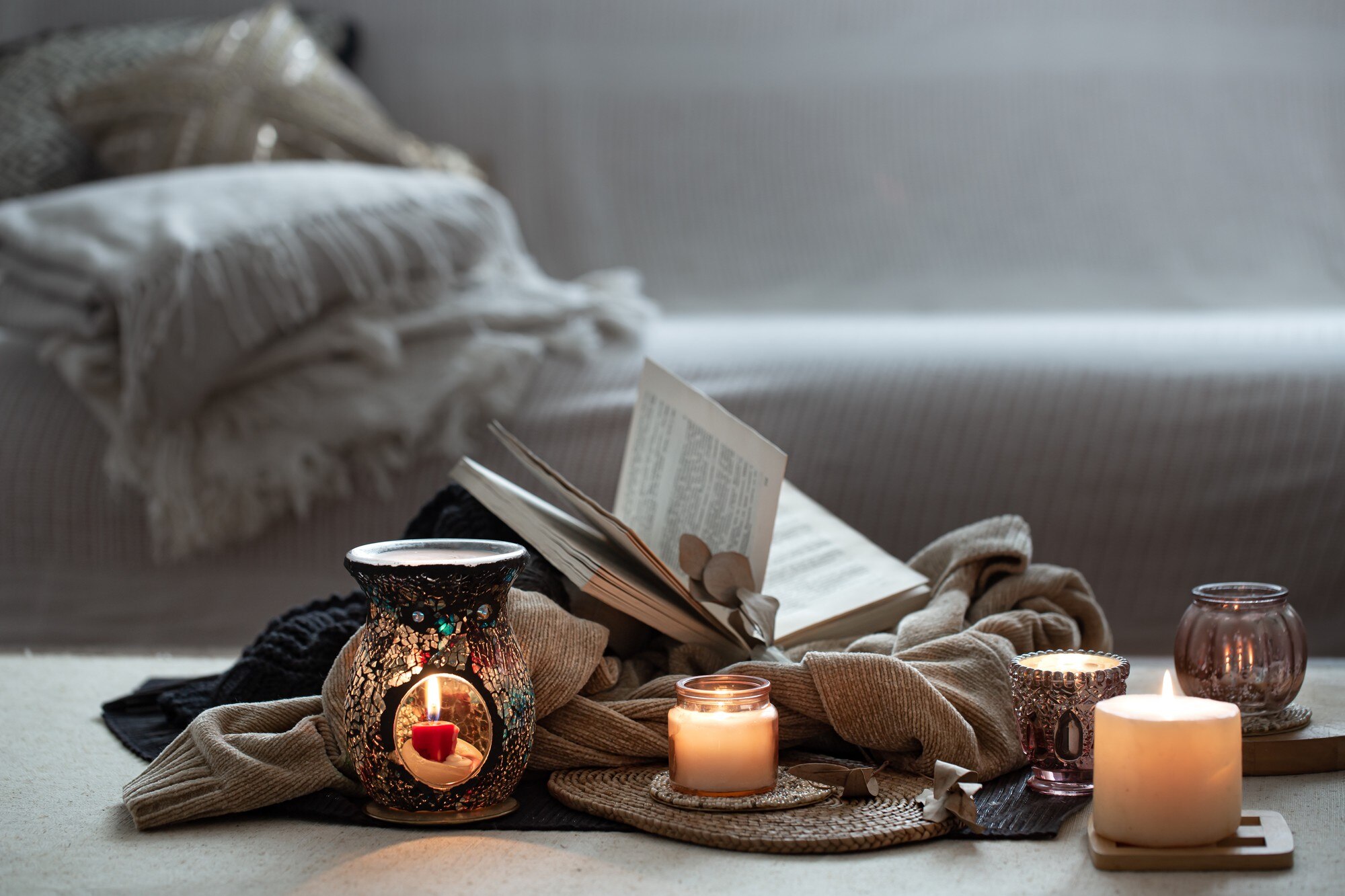 still life of burning candles books on sweaters o 784bd40b34668beb8163