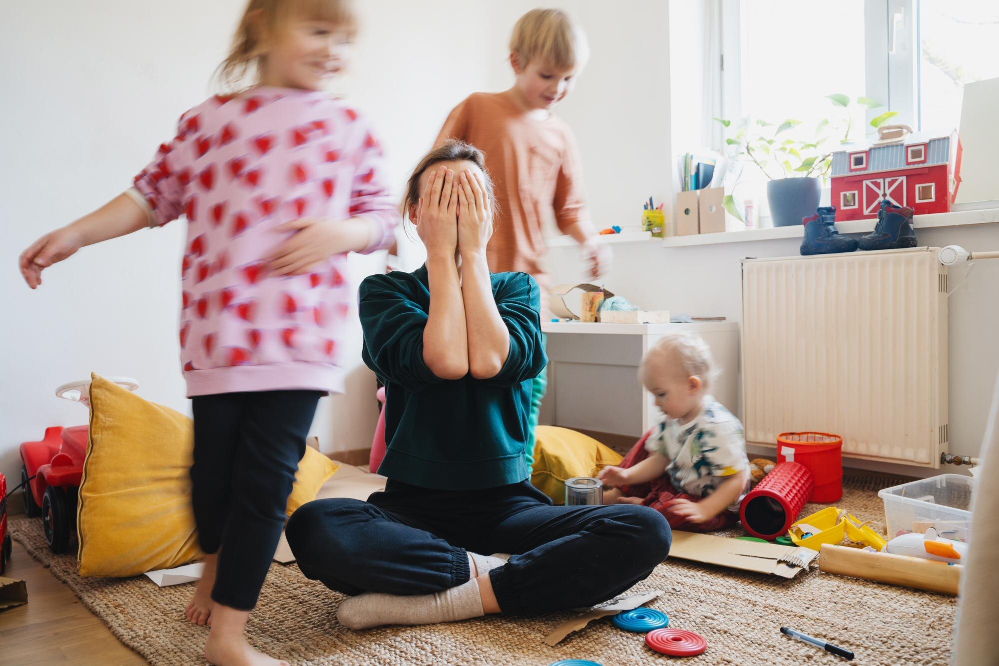stressed out mother sitting on floor in middle of cb67902280951c7f5064