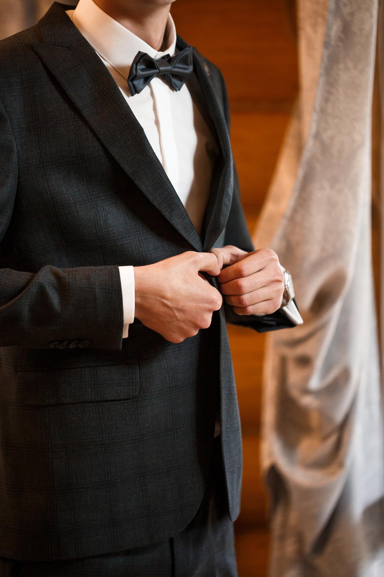 Crafting the Perfect Wedding Suit: Tailored Just for You in Bangkok Stylish Man Groom Buttoning A Button On His Jacket Baeb993392af5630f994