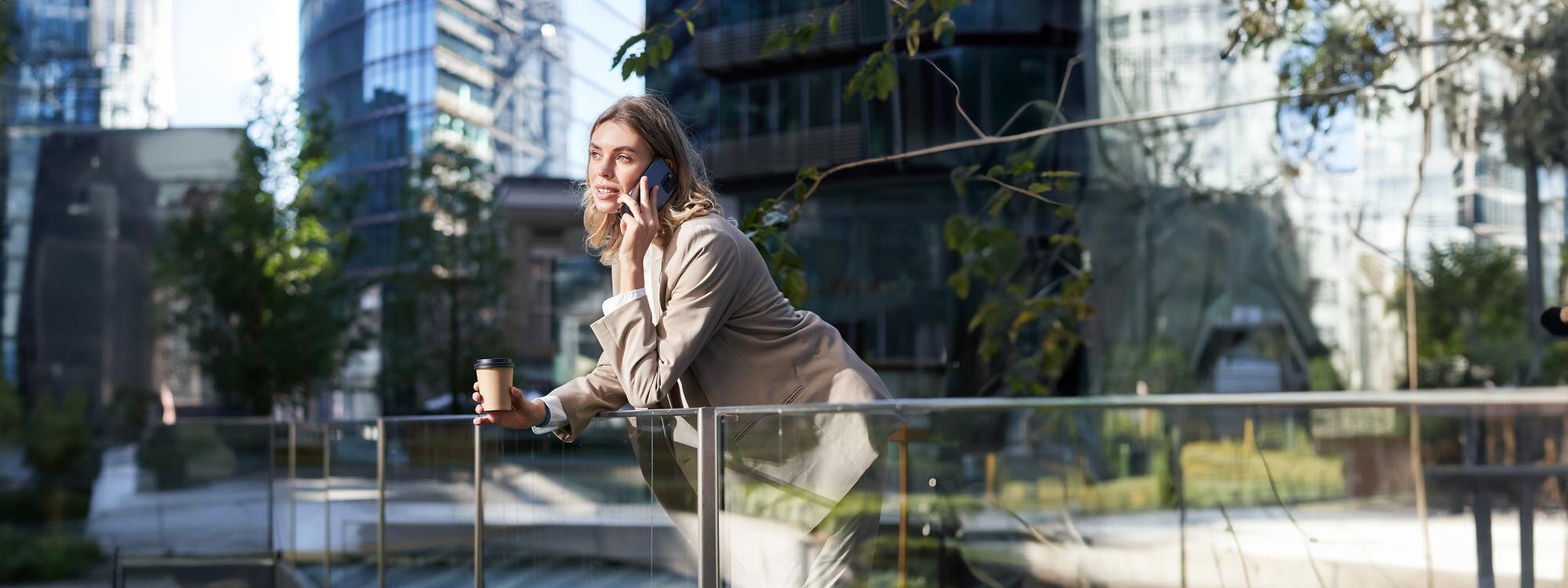 Featured image: Stylish office woman in beige suit talking on mobi-b6b175e8241233cf65bf