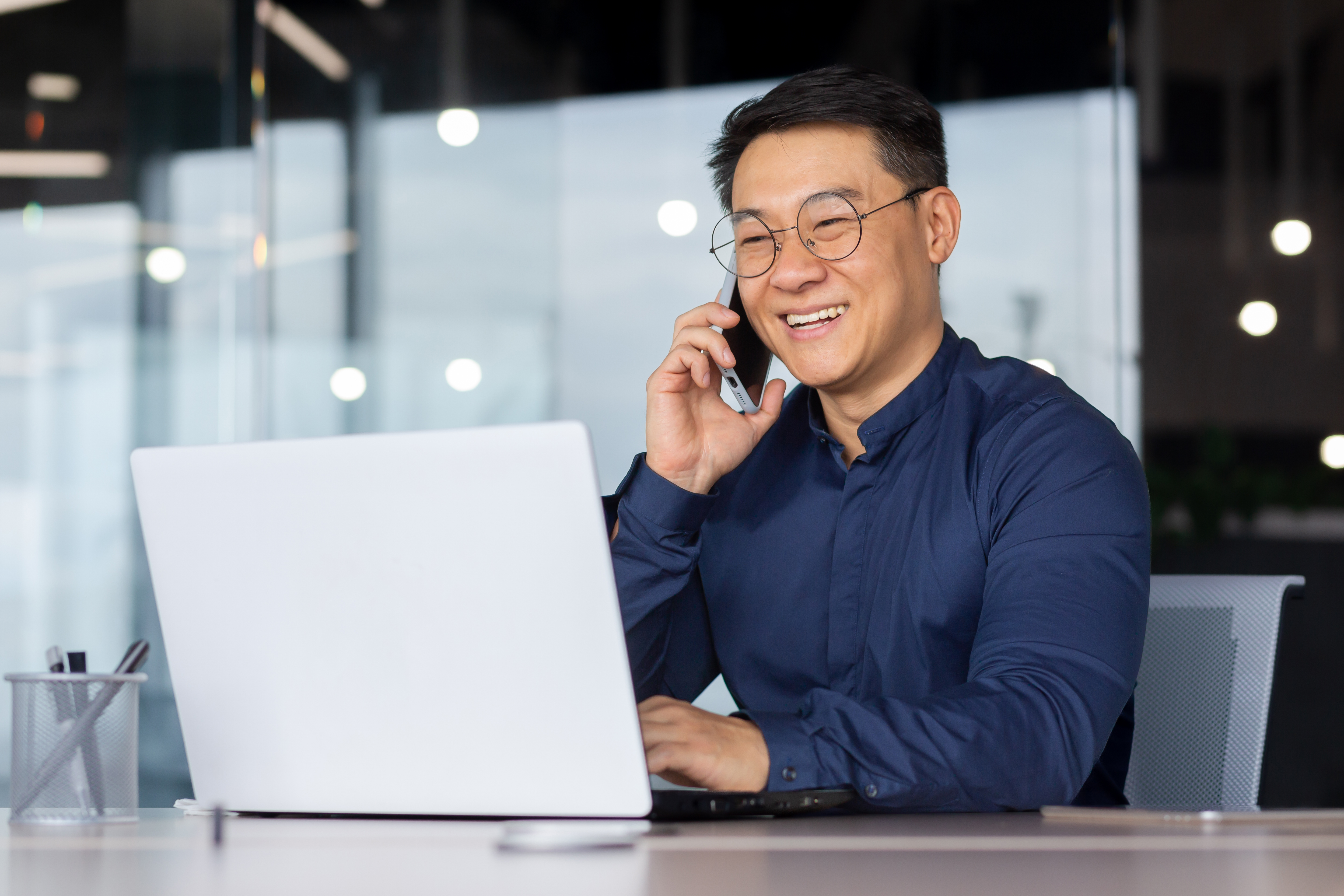 successful asian man smiling and talking on the ph 73dcaf848673a6a2390b