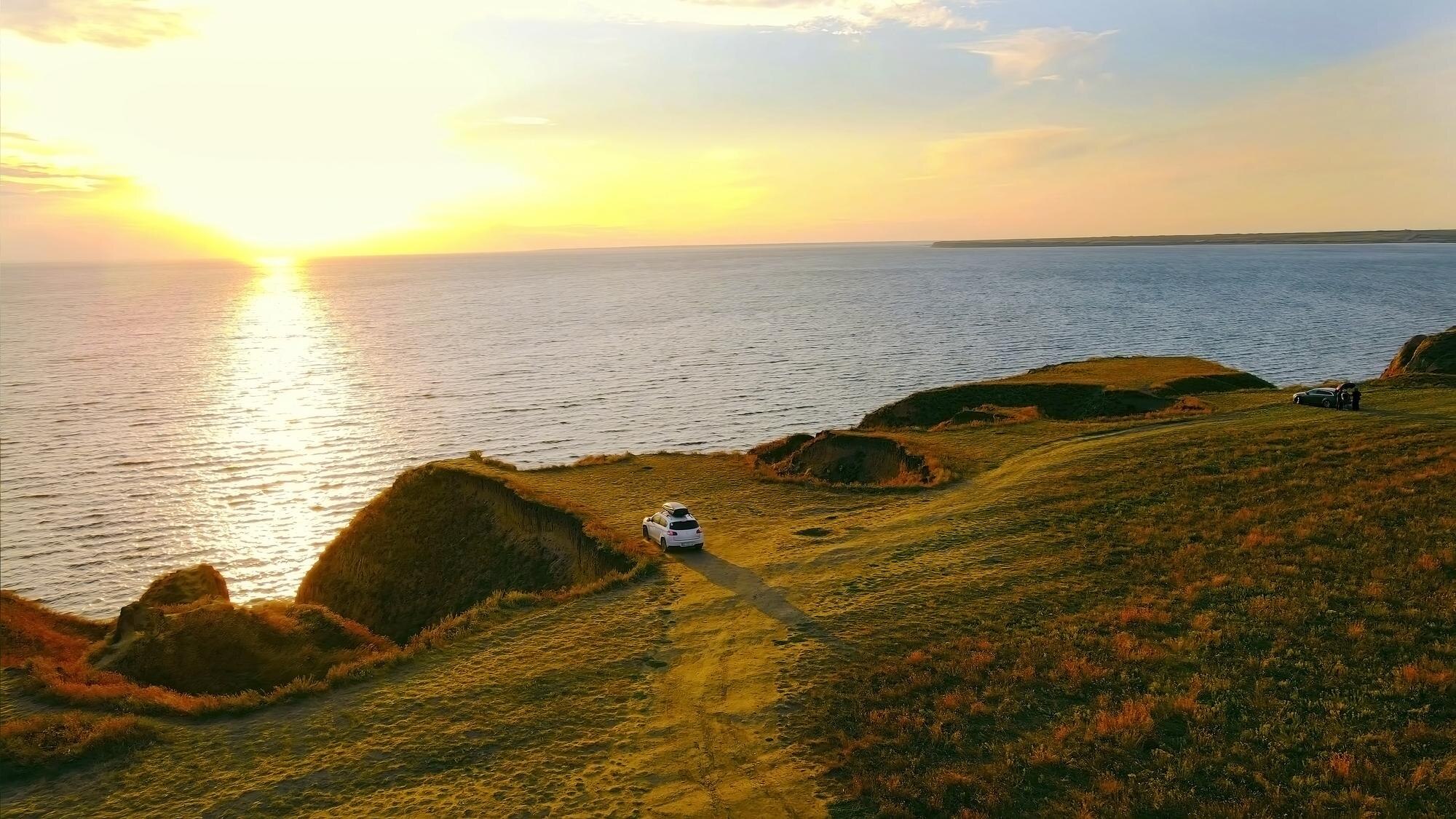 sunset over coastal cliff with parked cars beautif 854ca48f48ea1dc028ad BTOURS