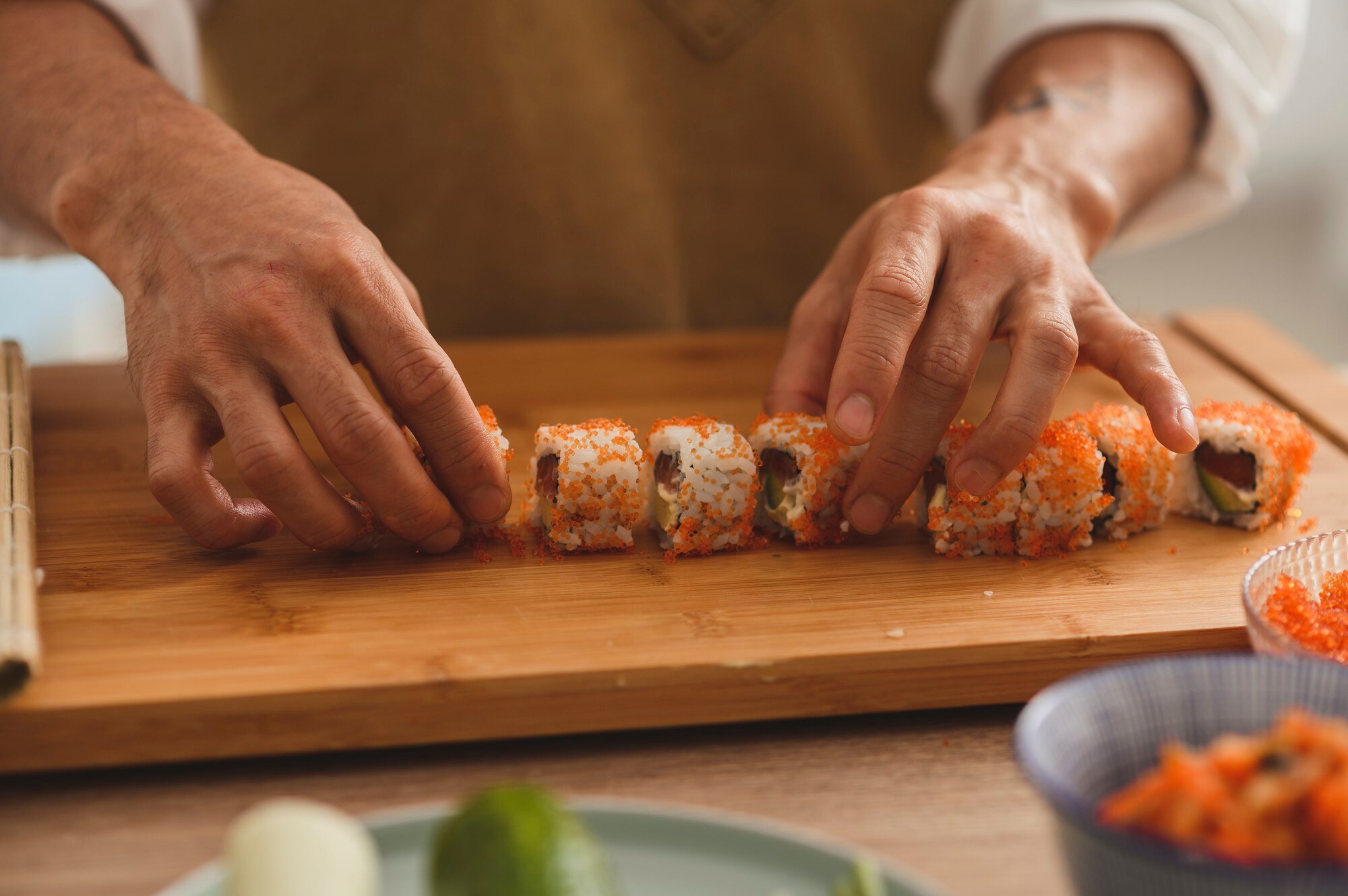 sushi masters hands closeup a male chef makes sush c92a74ad24de71aca7dd