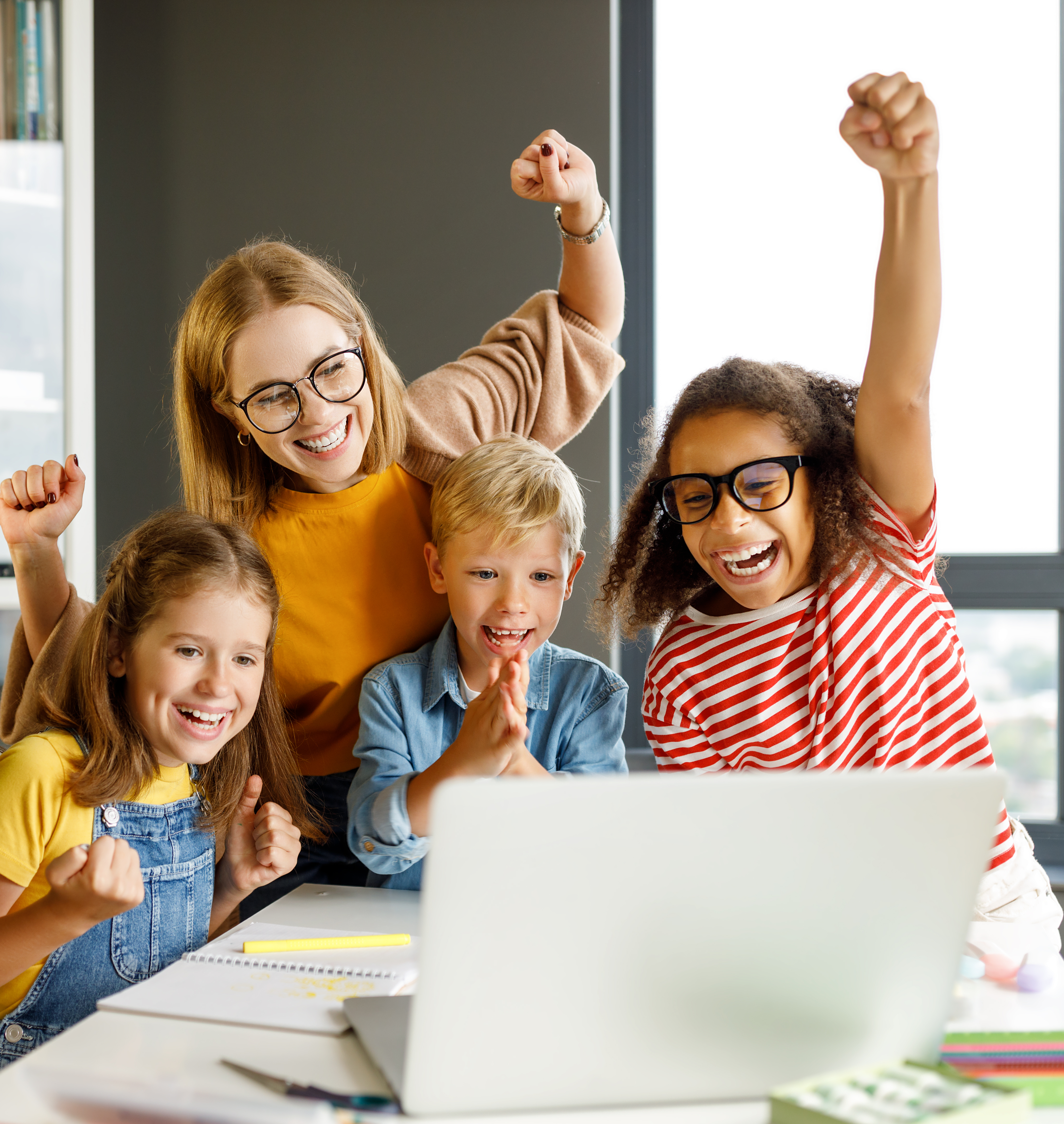 Teacher And Cheerful Schoolkids Looking At Lapt 5ca3429999bc5c5eee66
