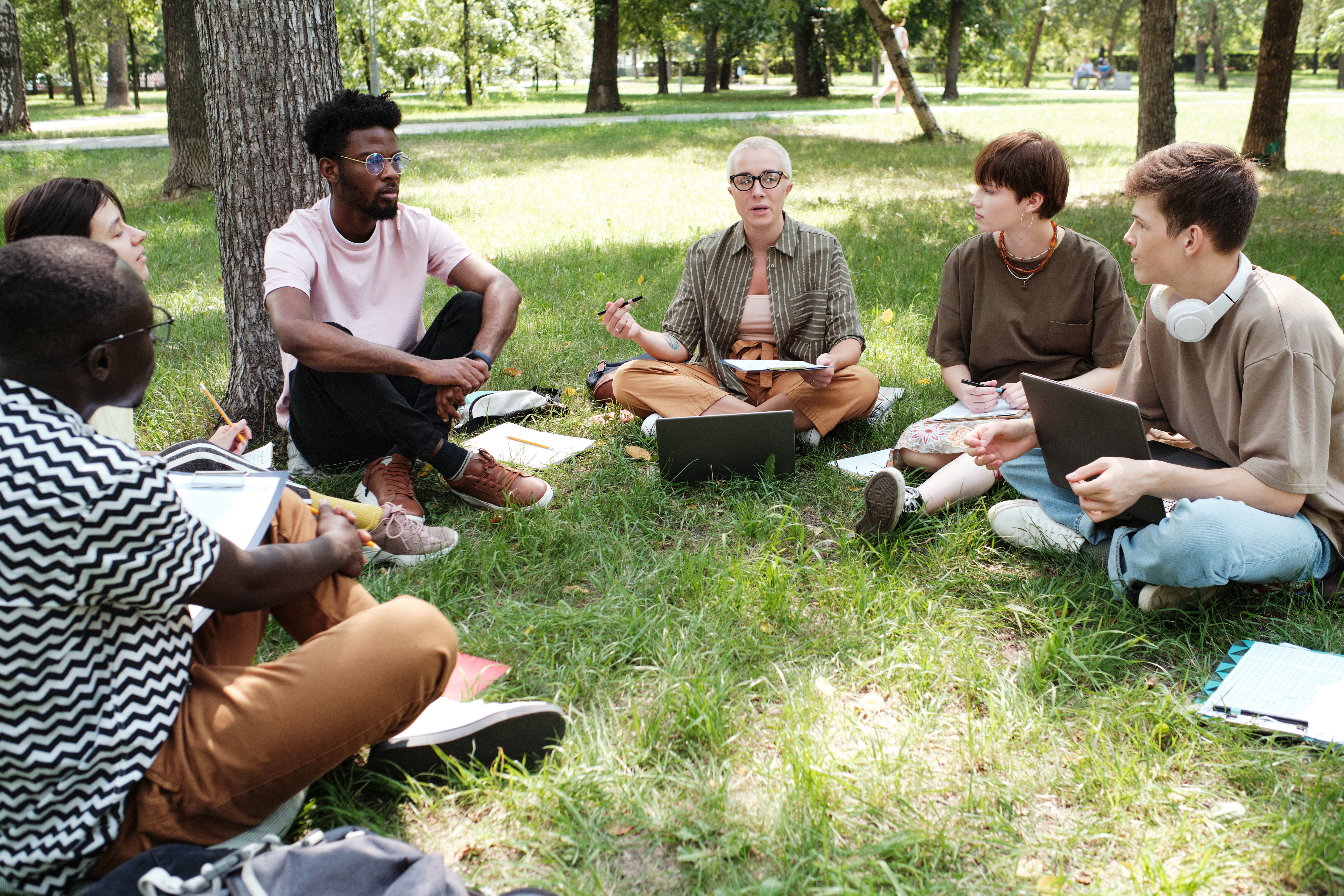 teacher with students studying outdoors d56296a514e493696dab